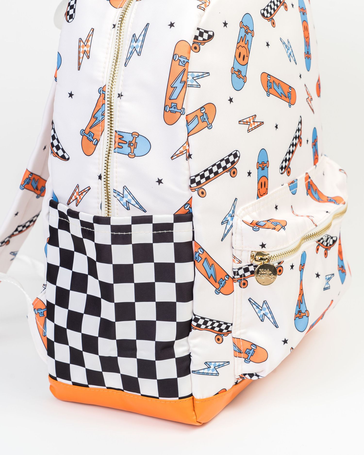 Playful backpack featuring skateboard print and checkered panels from multiple angles.