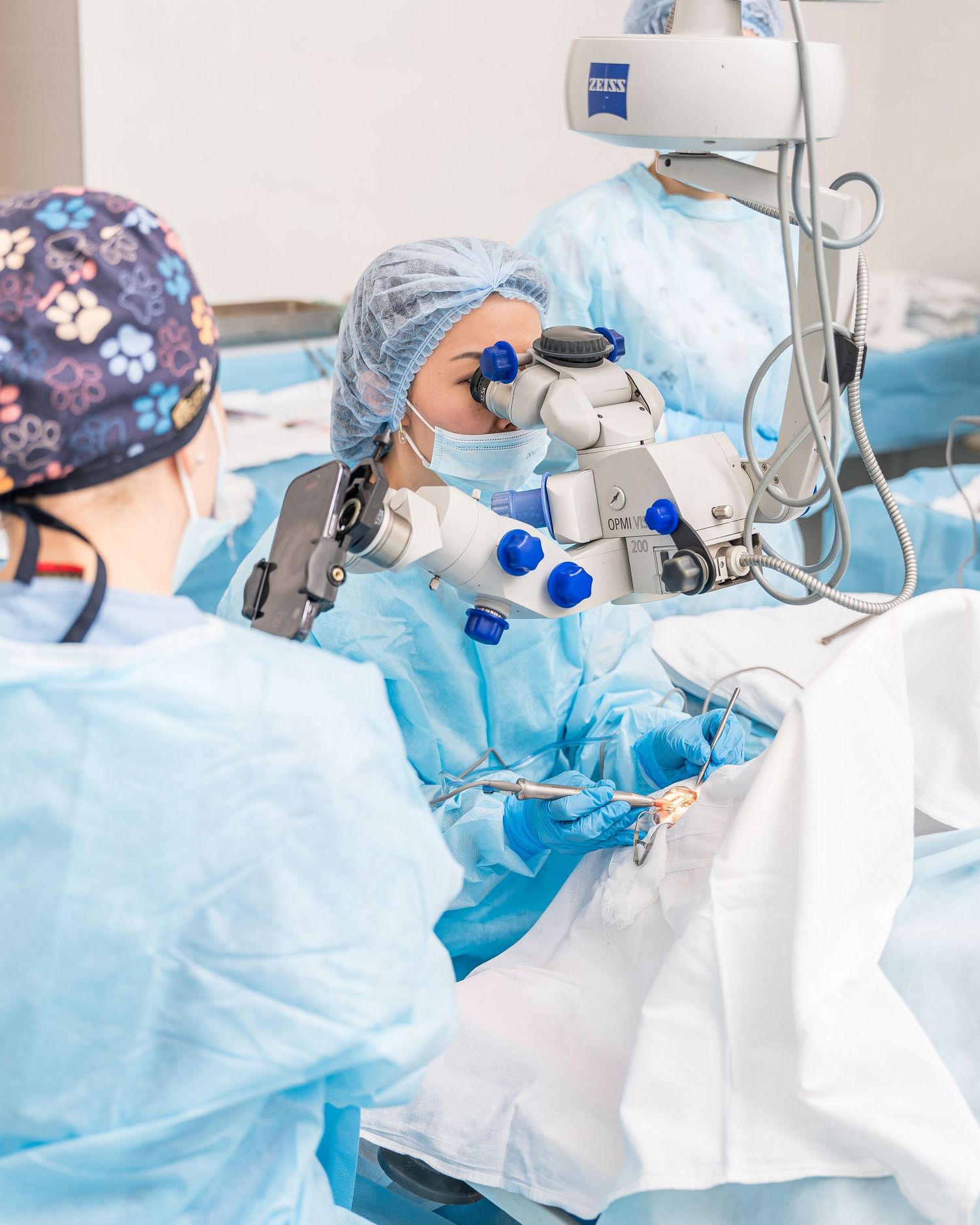 Surgical team performing medical procedure with specialized equipment in operating theater.