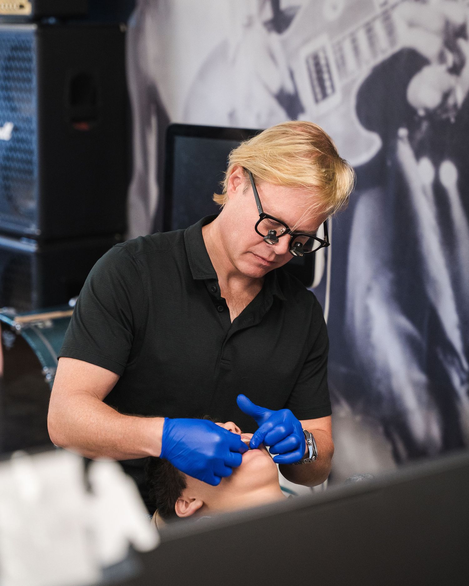 Medical professional performing dental examination in clinical setting.