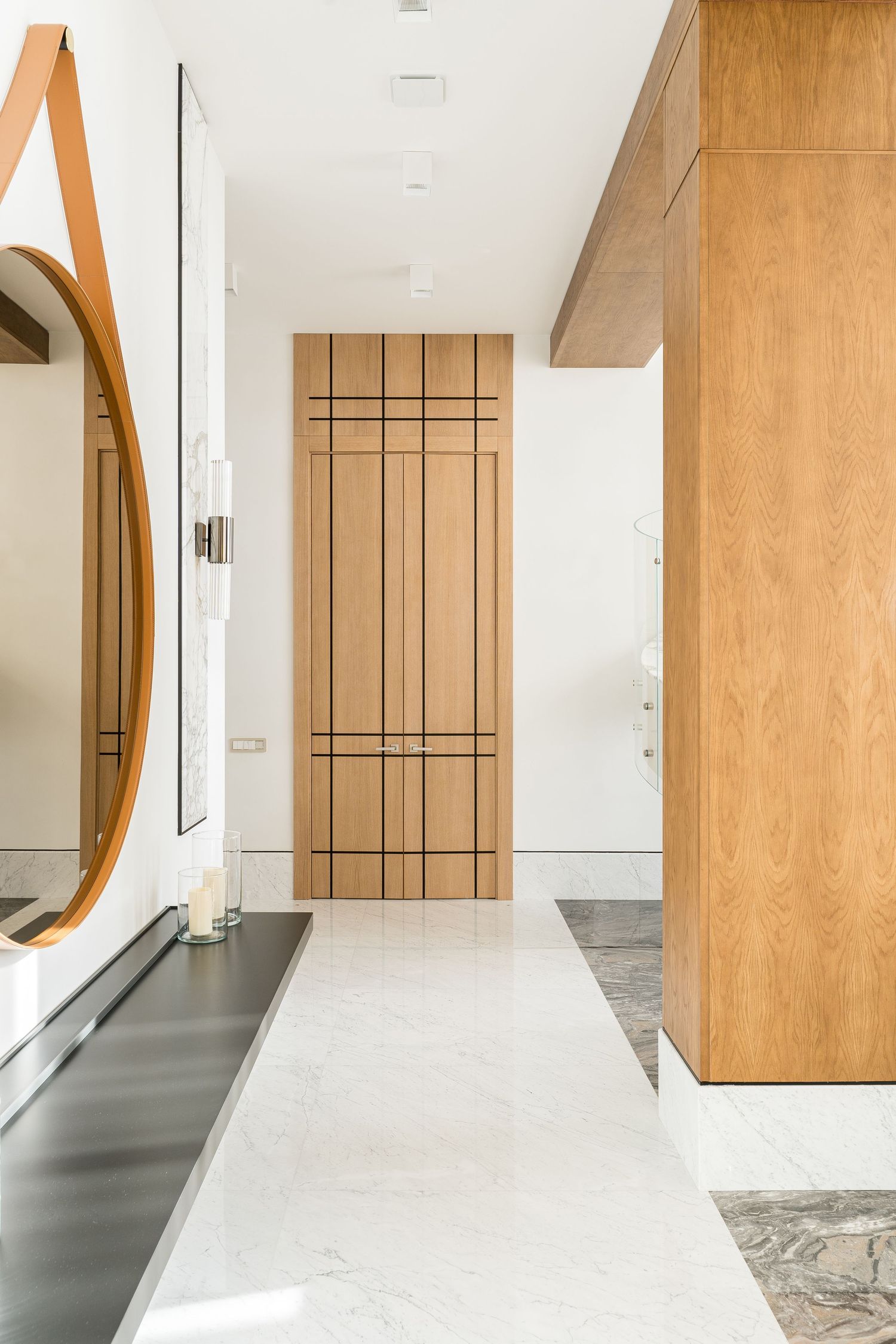 Modern hallway with wooden accent walls and marble flooring in contemporary design.