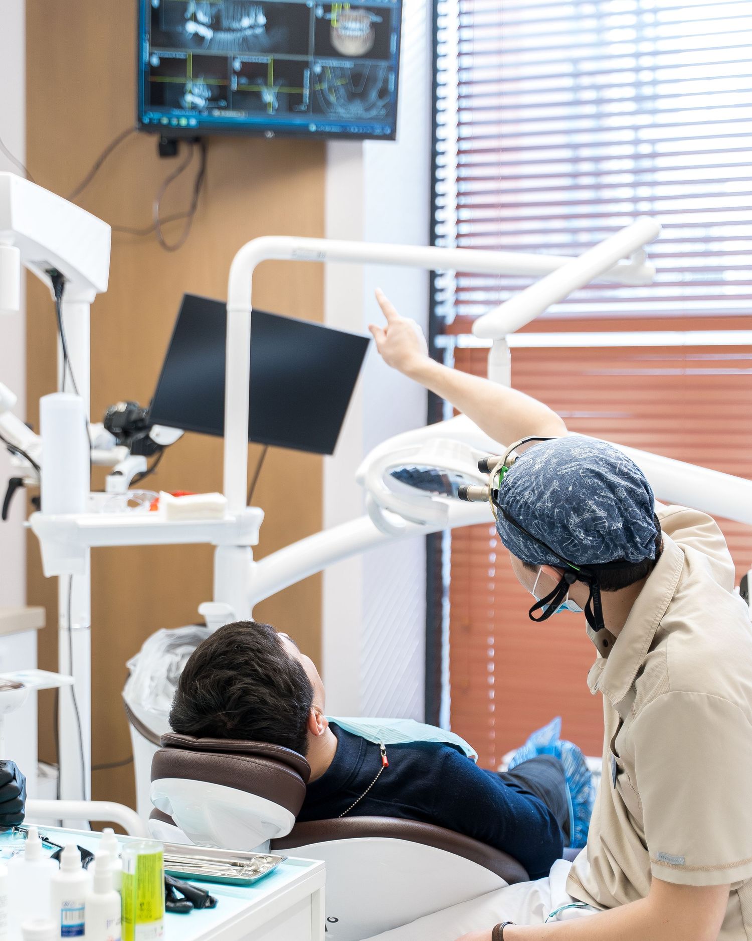 Modern dental clinic interior with multiple treatment stations and equipment.