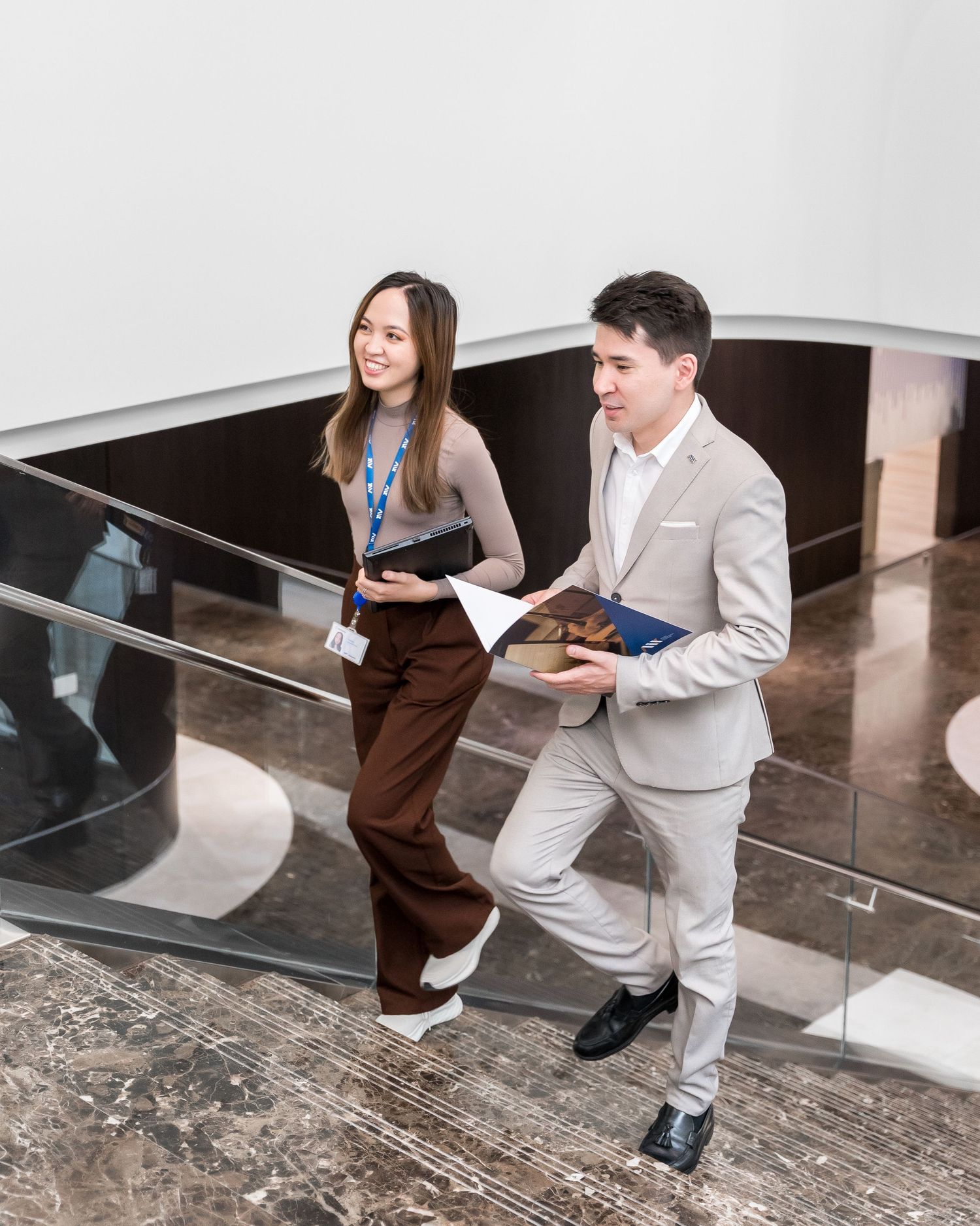Business meeting in modern office space with polished stone floors.
