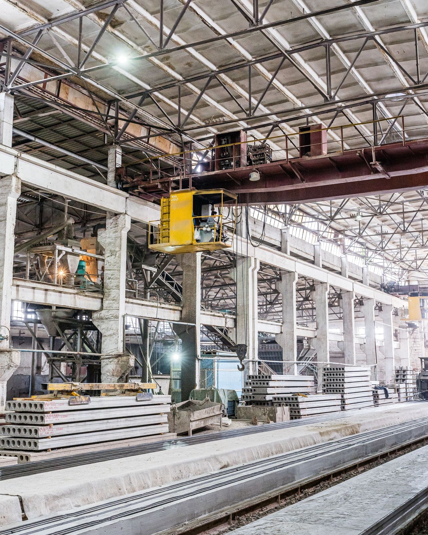Long production line with conveyor systems in a modern concrete manufacturing plant.