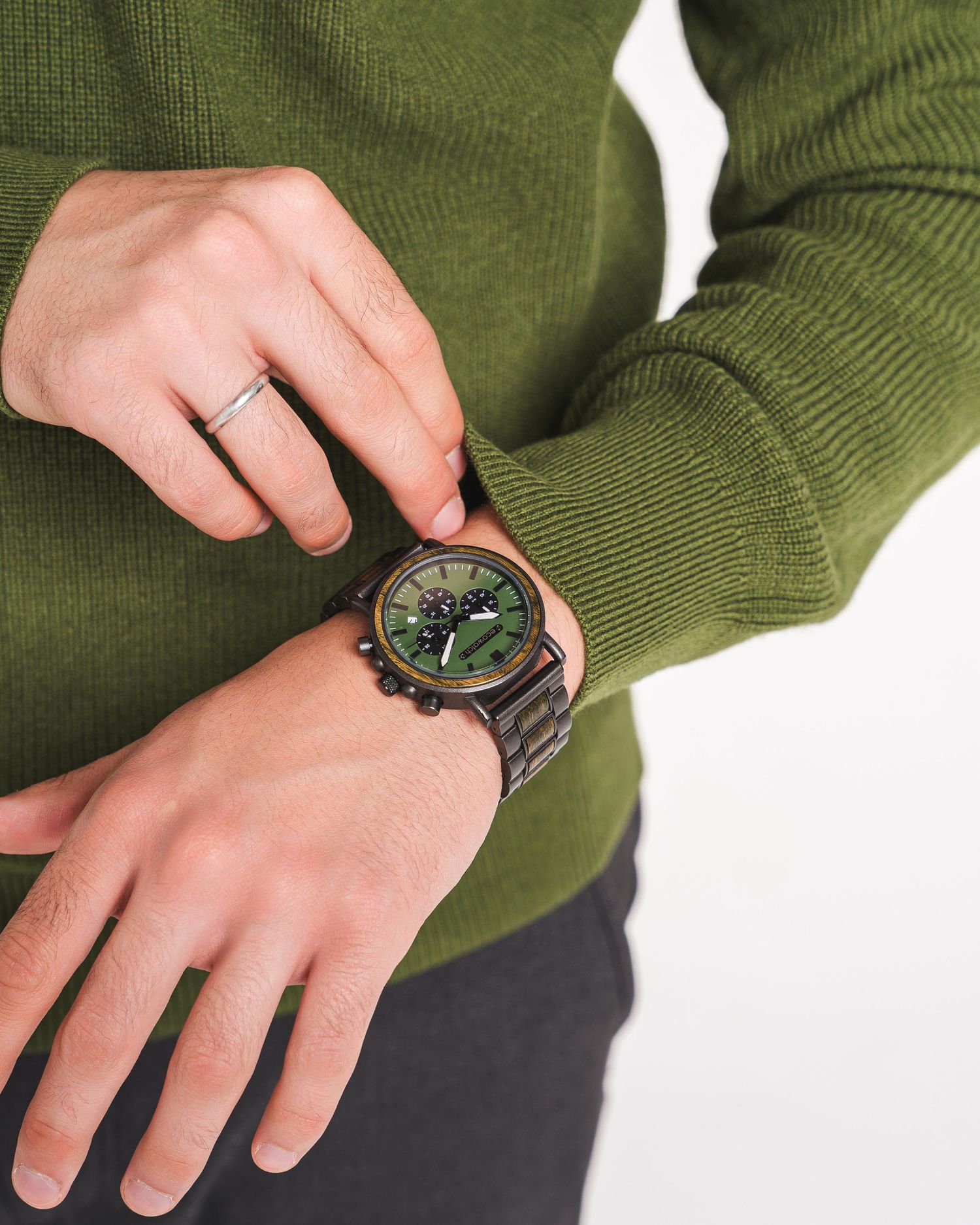 Green sweater sleeve with watch detail shots showing timepiece styling.