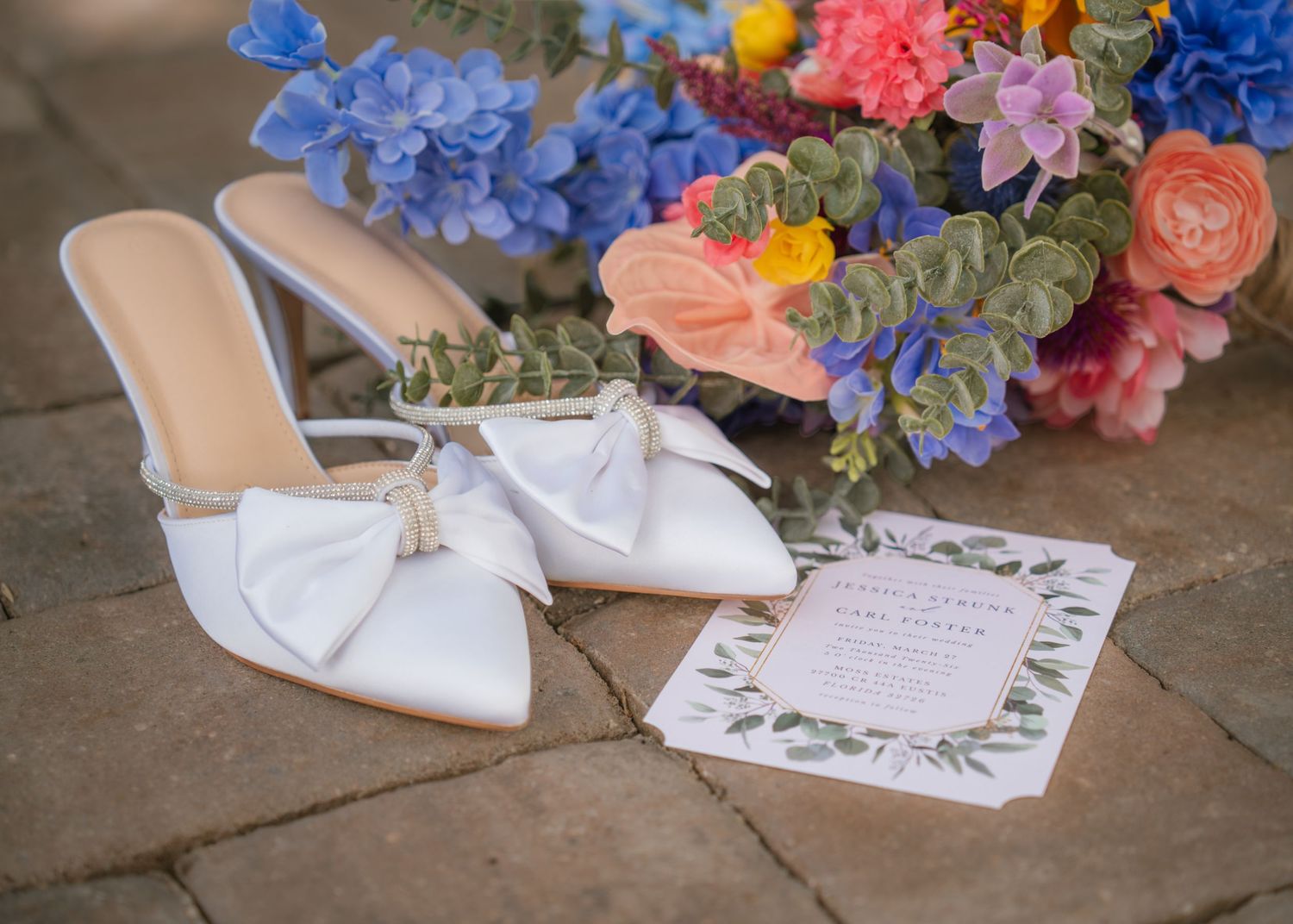 Wedding detail photos featuring invitations, shoes, and bouquet at Moss Estates in Central Florida