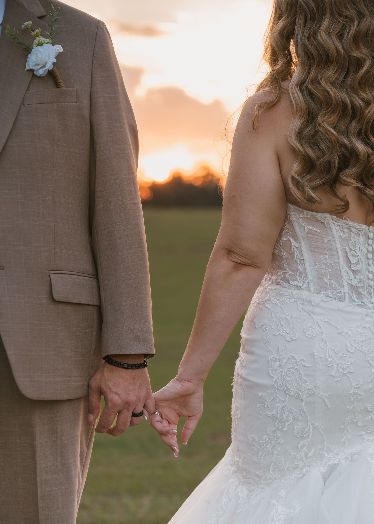 Sunset wedding portraits of the bride and groom surrounded by the open fields at Moss Estates wedding venue in Eustis, Florida.