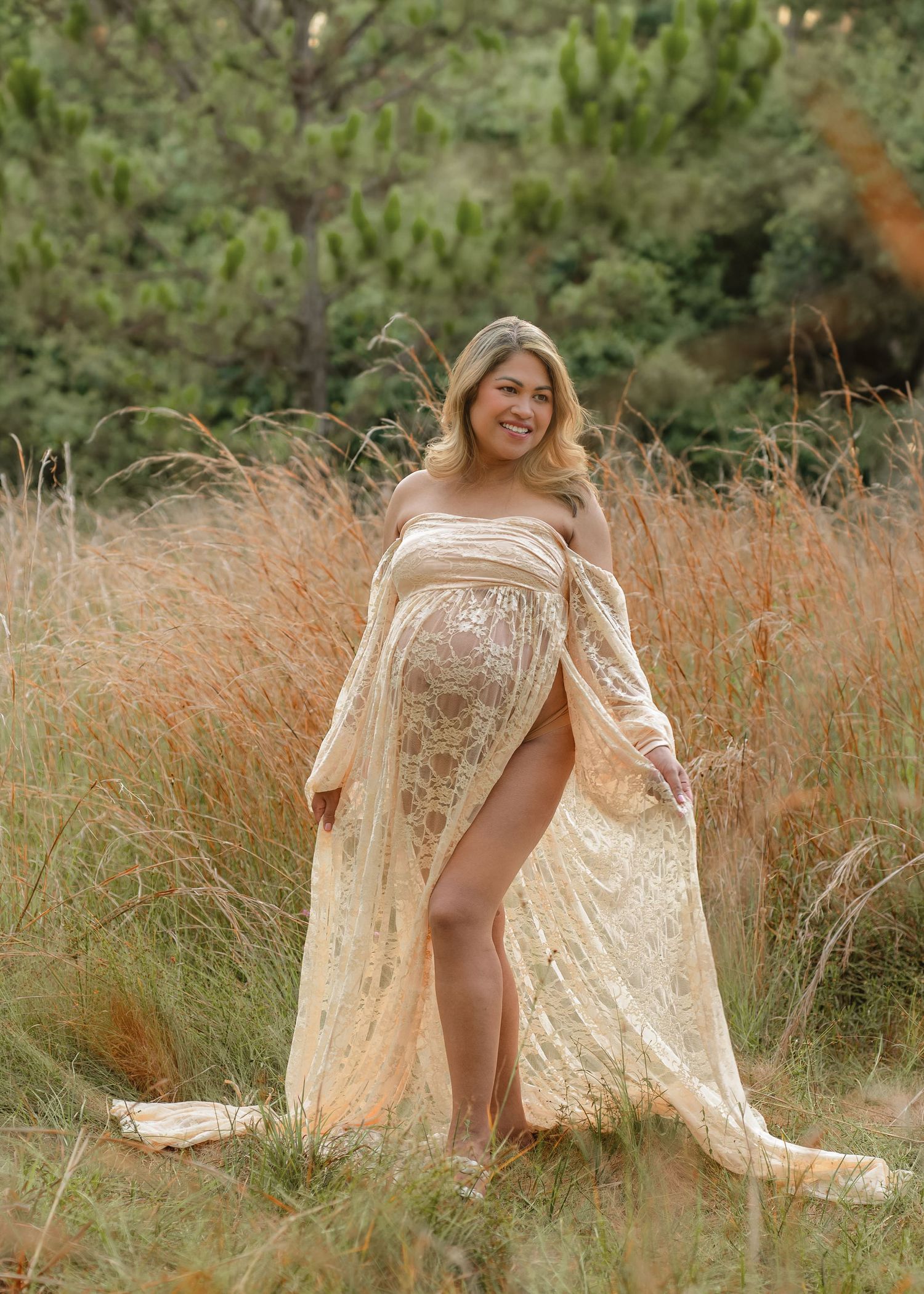 Warm and timeless maternity session photographed among the tall grass at Lake Runnymede Conservation Area in St. Cloud.