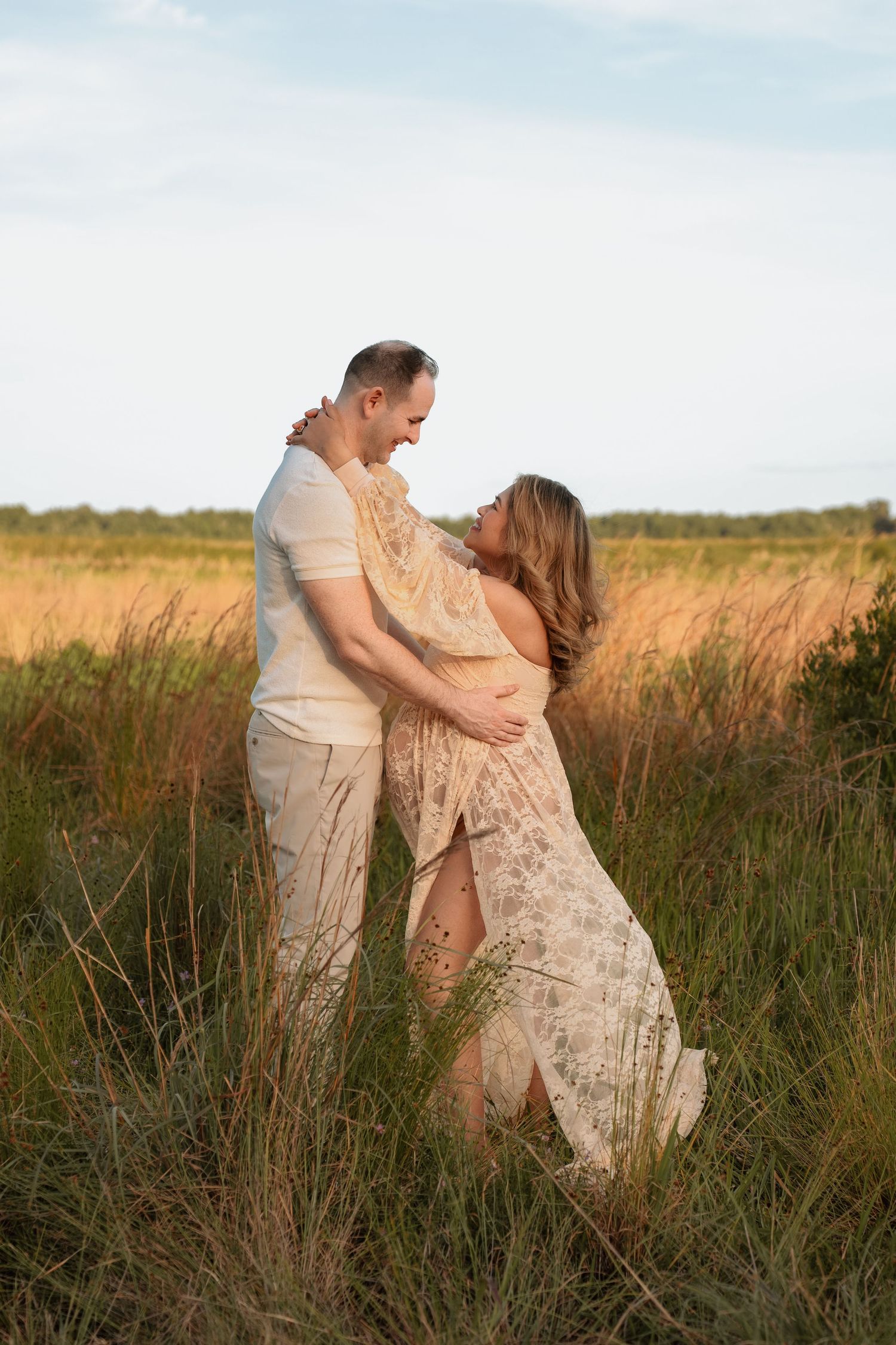 Romantic maternity session featuring an expecting mother and father-to-be at Lake Runnymede Conservation Area in St. Cloud, Florida.