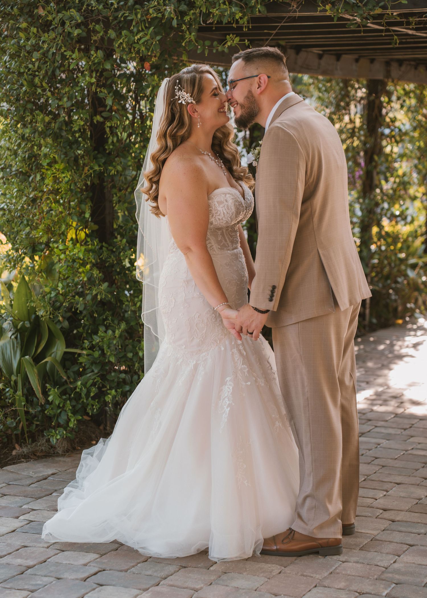 Bride and groom sharing romantic sunset wedding portraits beneath the majestic oak trees at Moss Estates wedding venue in Eustis, Florida.