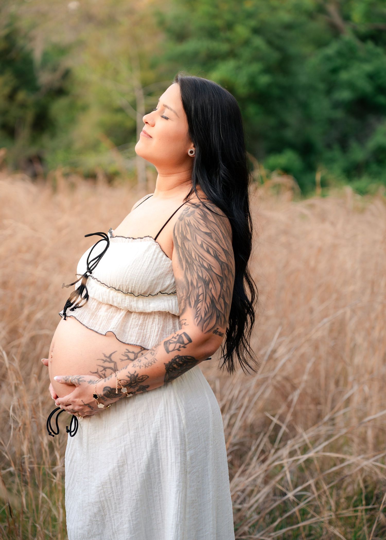 Beautiful maternity portrait of an expecting mother surrounded by tall grass at Lake Runnymede Conservation Area in St Cloud Florida