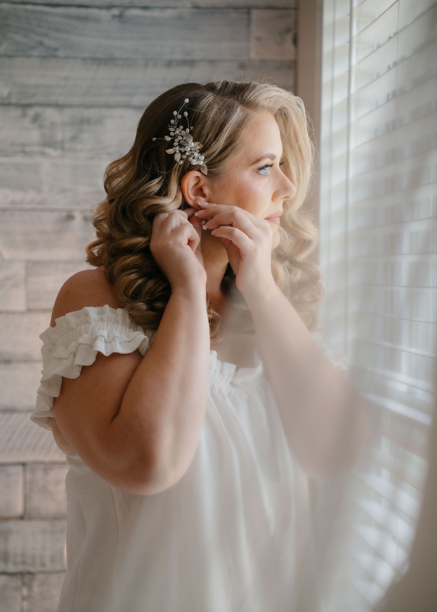 Bride getting ready in the bright bridal suite at Moss Estates wedding venue before her Central Florida wedding ceremony.
