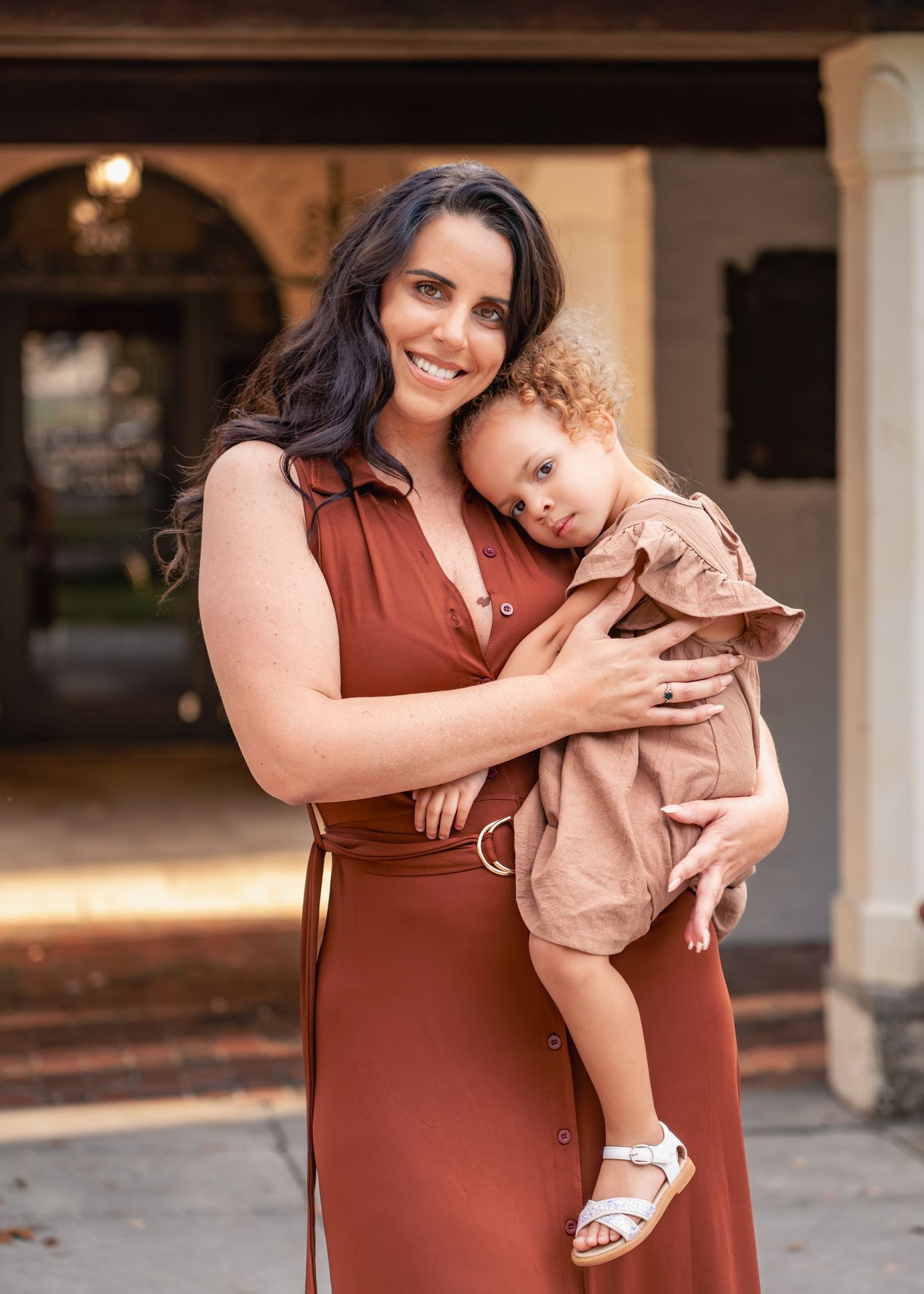 Mother embracing her children during an outdoor family session at Rollins College in Winter Park.