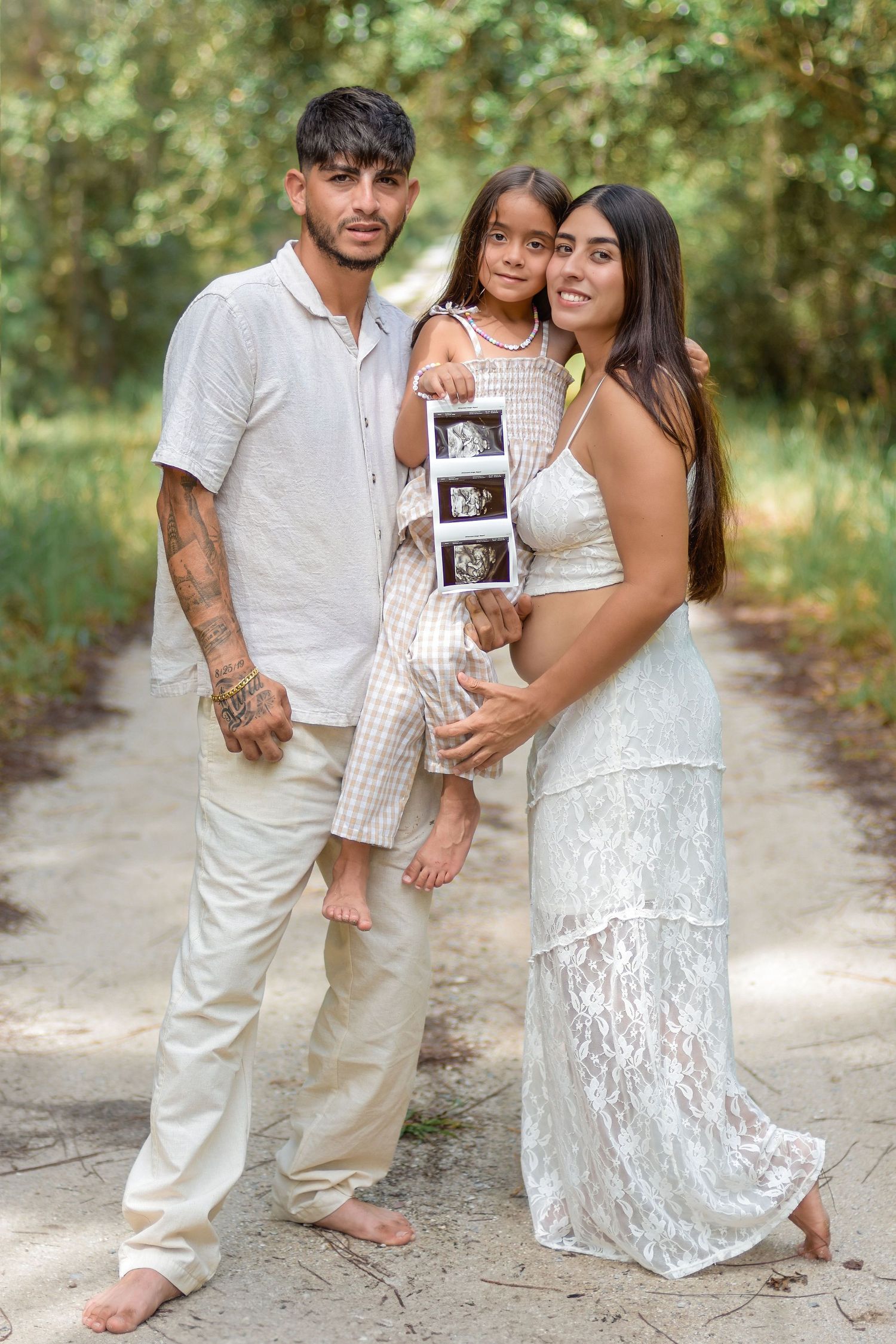 family pregnancy announcement photographer capturing joyful outdoor portraits in St. Cloud