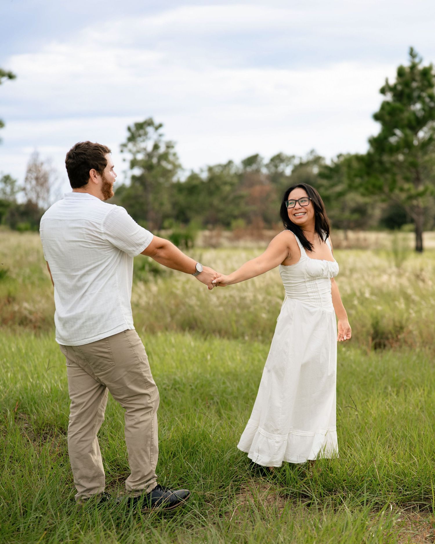 Natural engagement photos of couple walking through Lake Louisa State Park