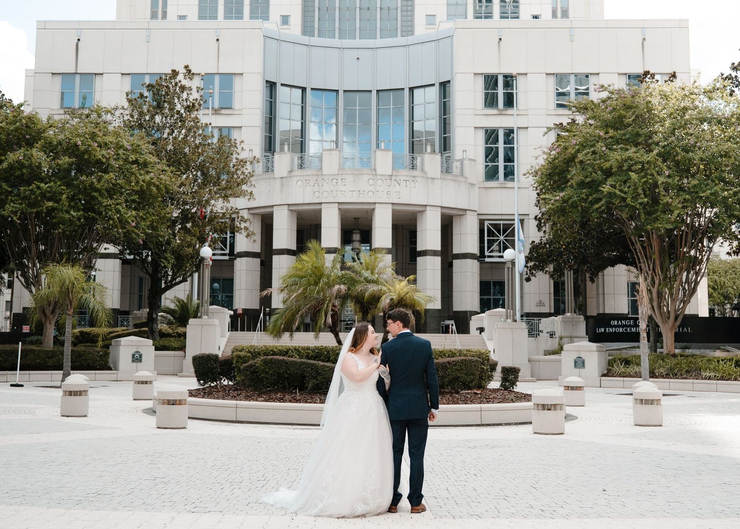 Destination elopement portraits of British newlyweds in Orlando Florida outside Orange County Courthouse after ceremony