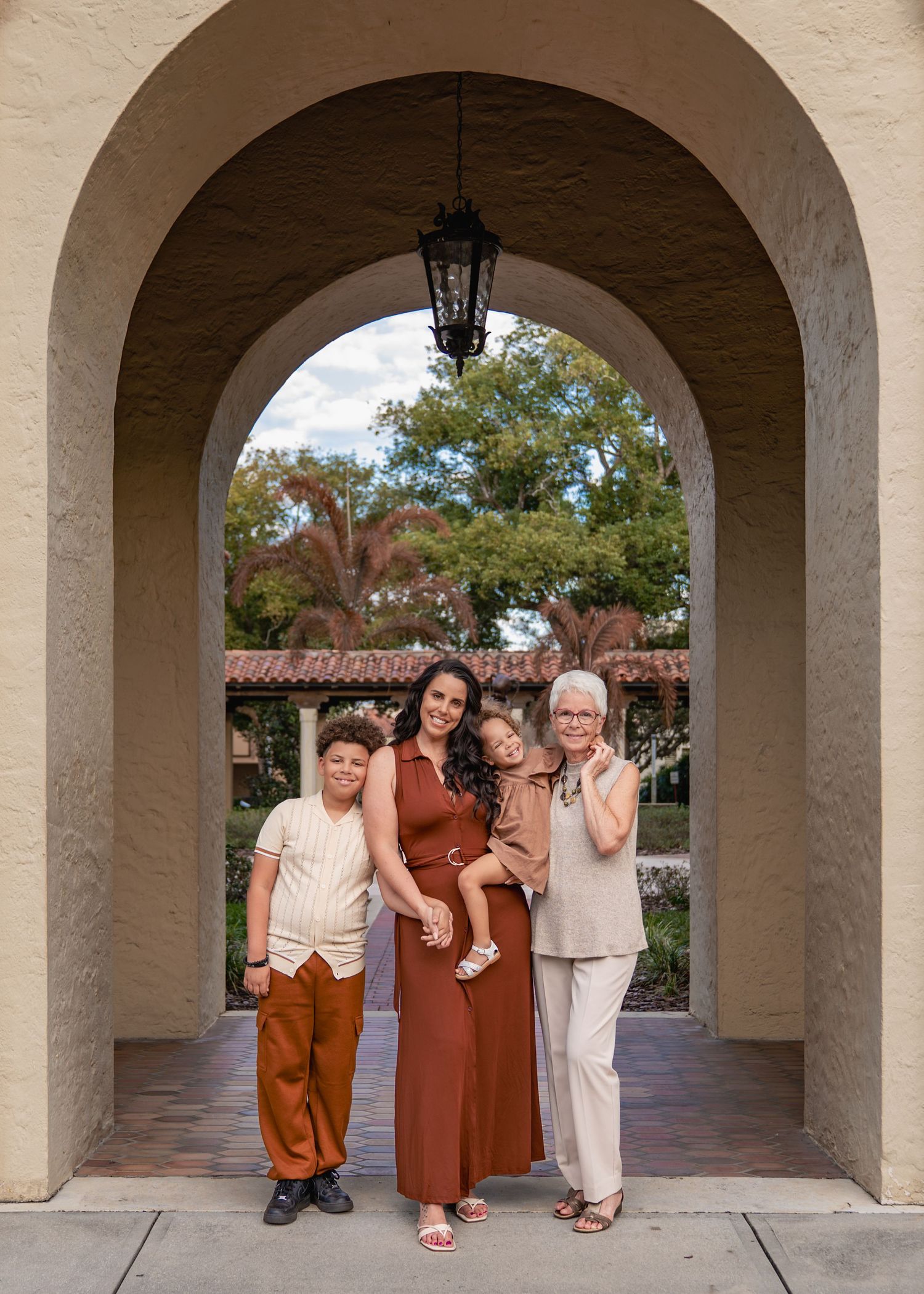 Outdoor family portraits surrounded by the beautiful architecture of Rollins College in Winter Park.