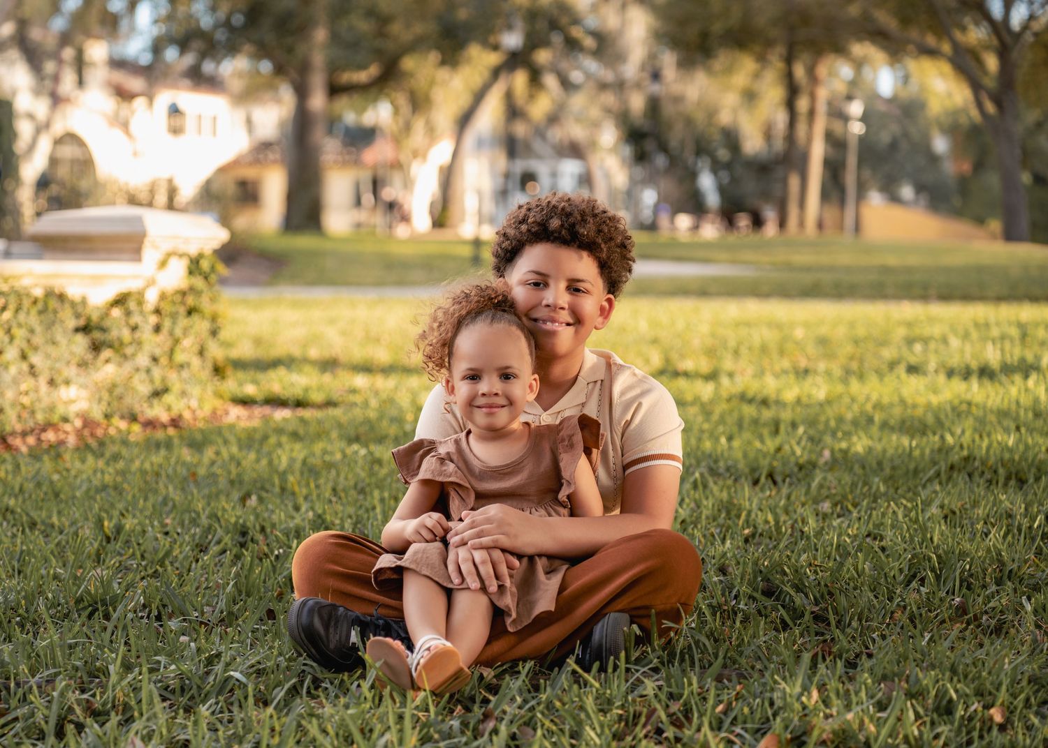 Sibling portraits captured beneath the beautiful architecture of Rollins College.