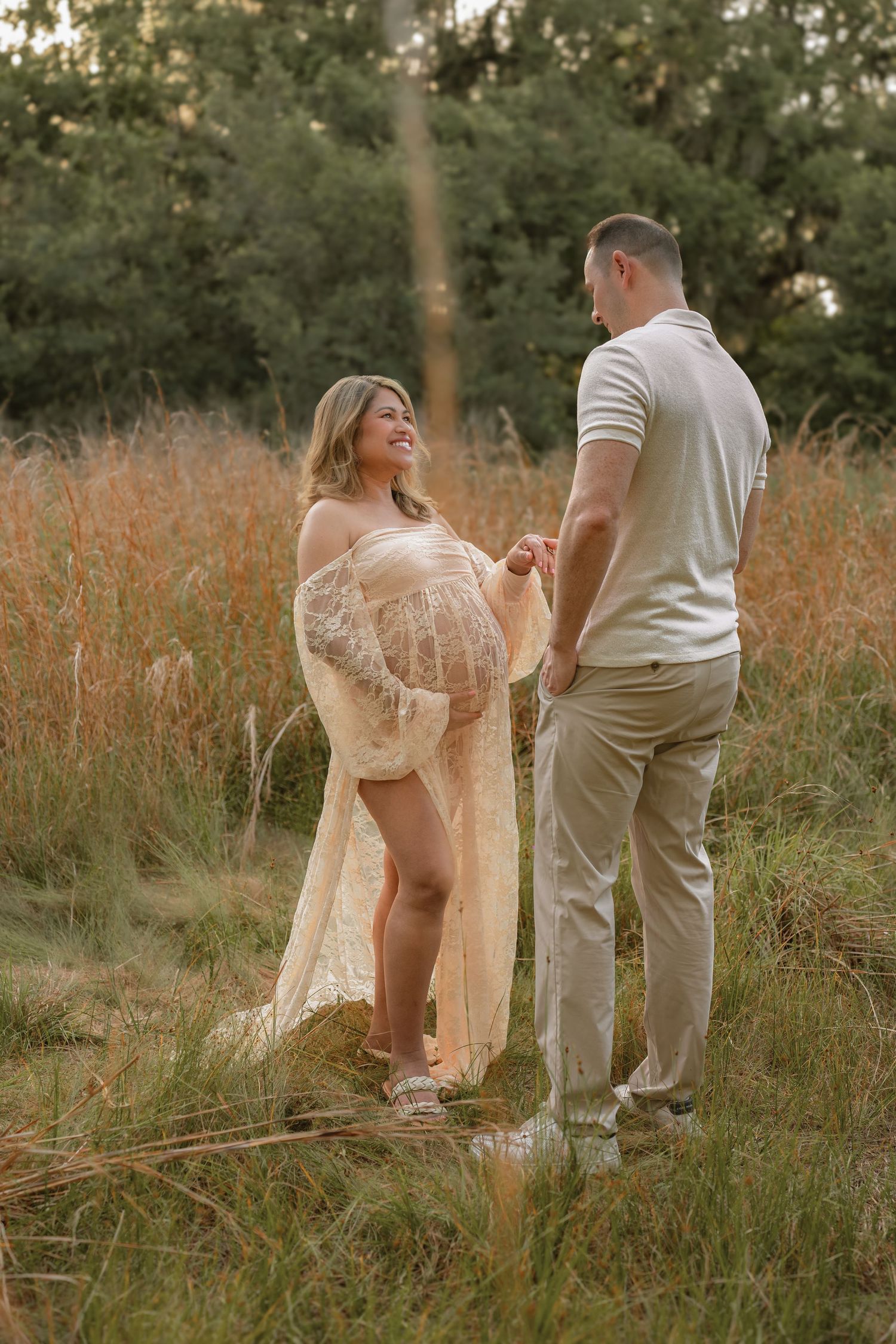 Expecting parents sharing a quiet moment together during their outdoor maternity session at Lake Runnymede Conservation Area.