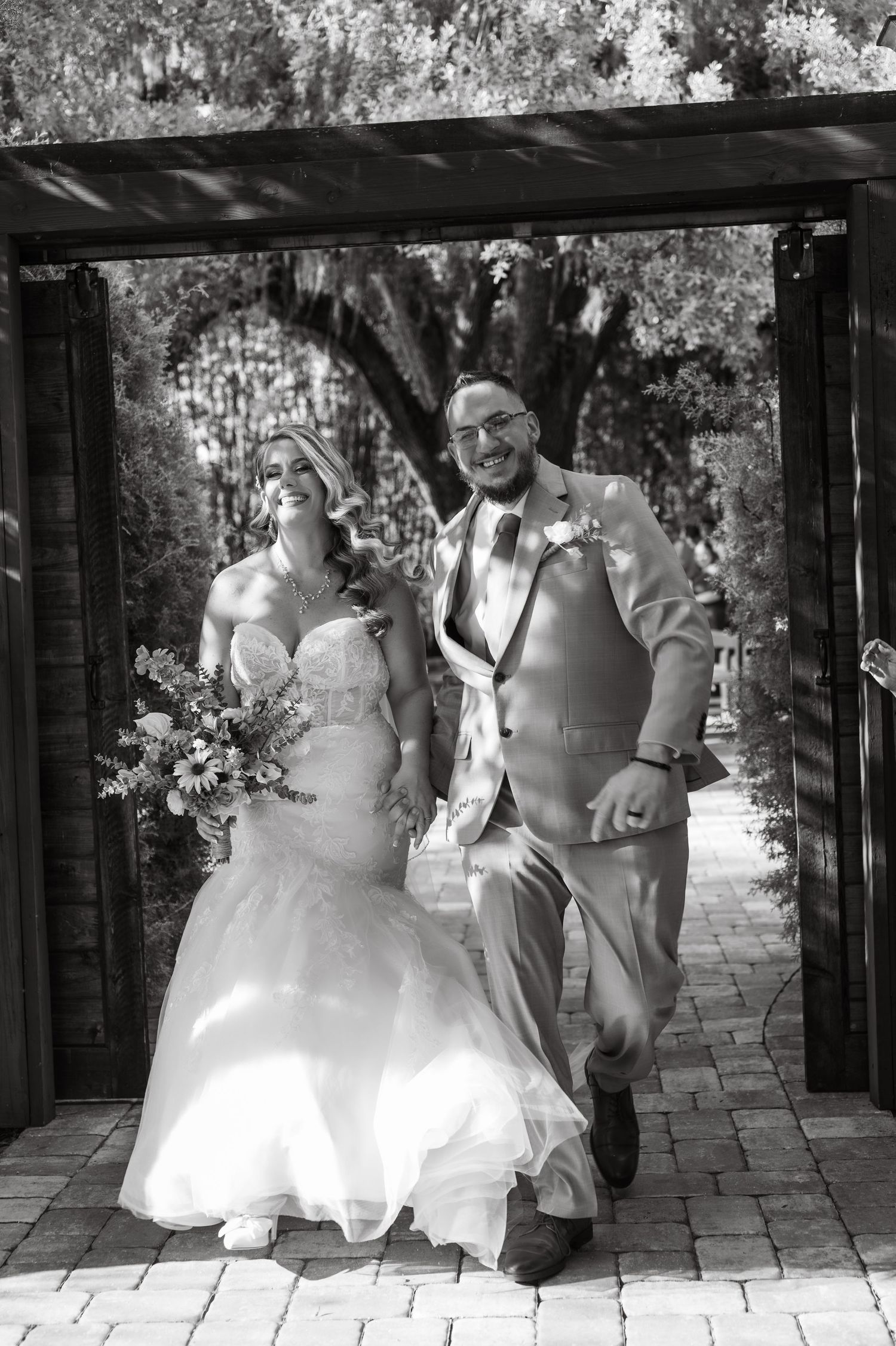 Joyful bride and groom celebrating immediately after their outdoor wedding ceremony at Moss Estates in Eustis, Florida.