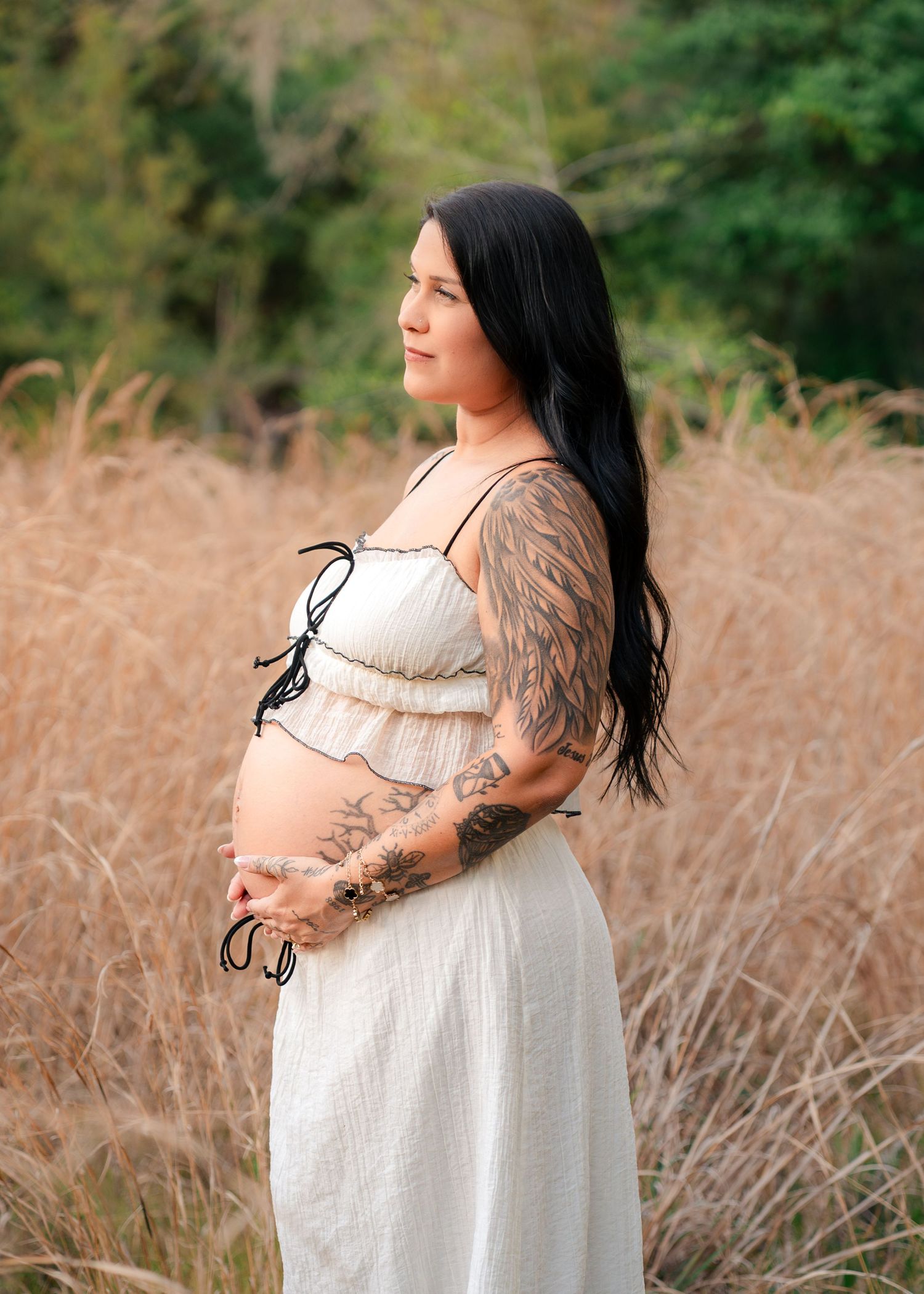 Beautiful maternity portrait of an expecting mother surrounded by tall grass at Lake Runnymede Conservation Area in St Cloud Florida