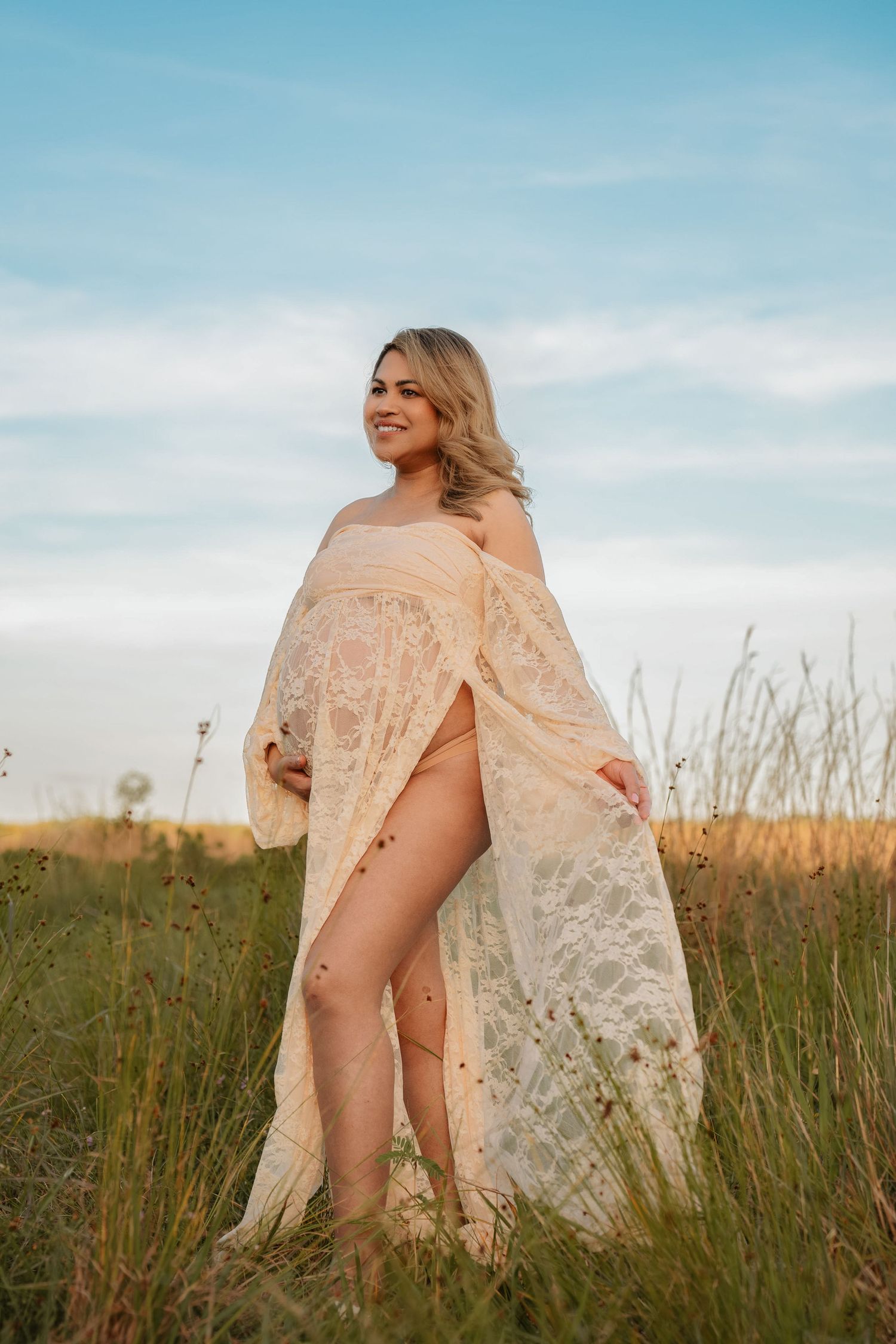Expecting mother wearing a flowing maternity dress during a rustic outdoor session at Lake Runnymede Conservation Area in St. Cloud, Florida