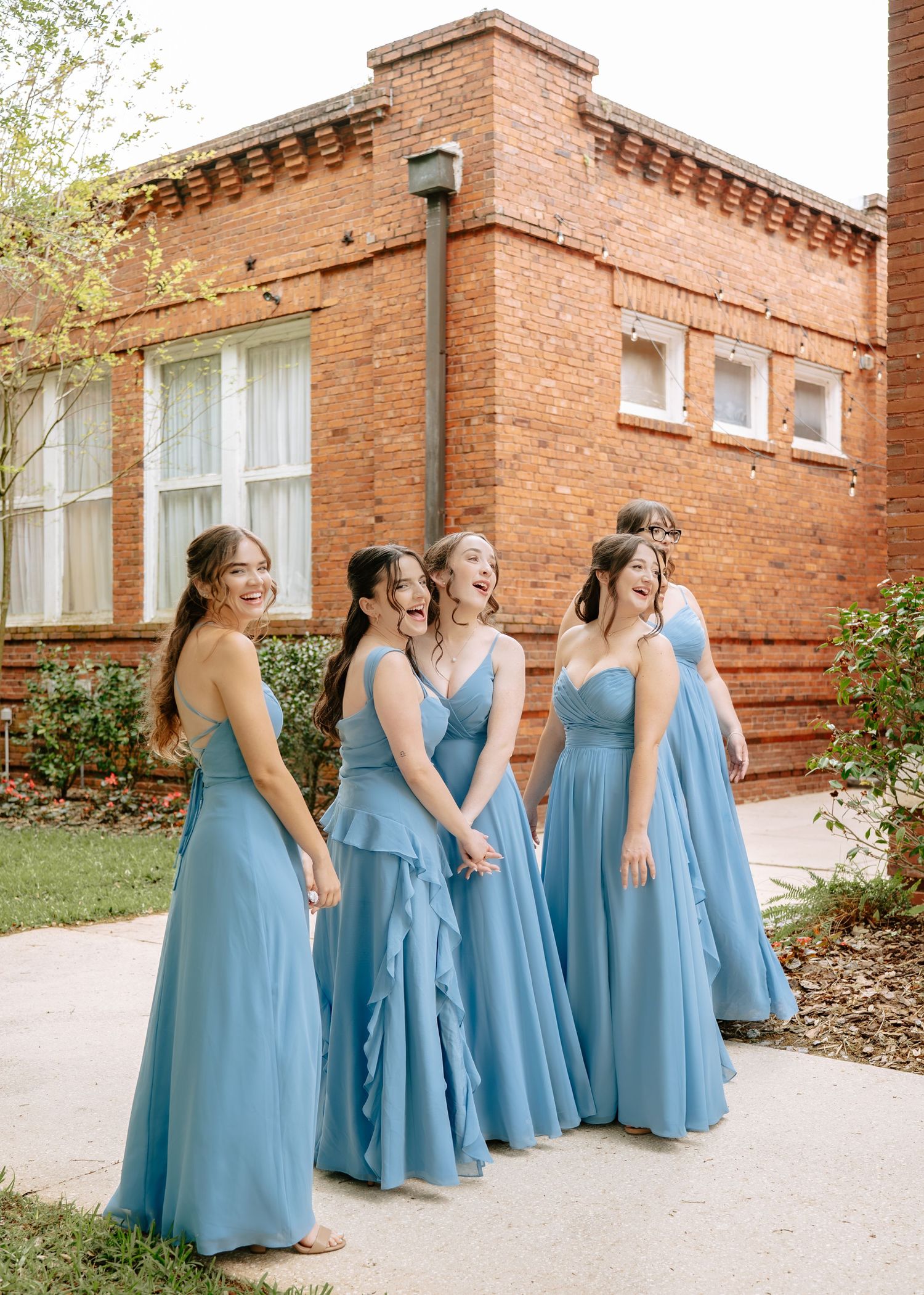 Bridesmaids seeing the bride for the first time before the wedding ceremony at Historic Venue 1902 in Sanford, Florida.