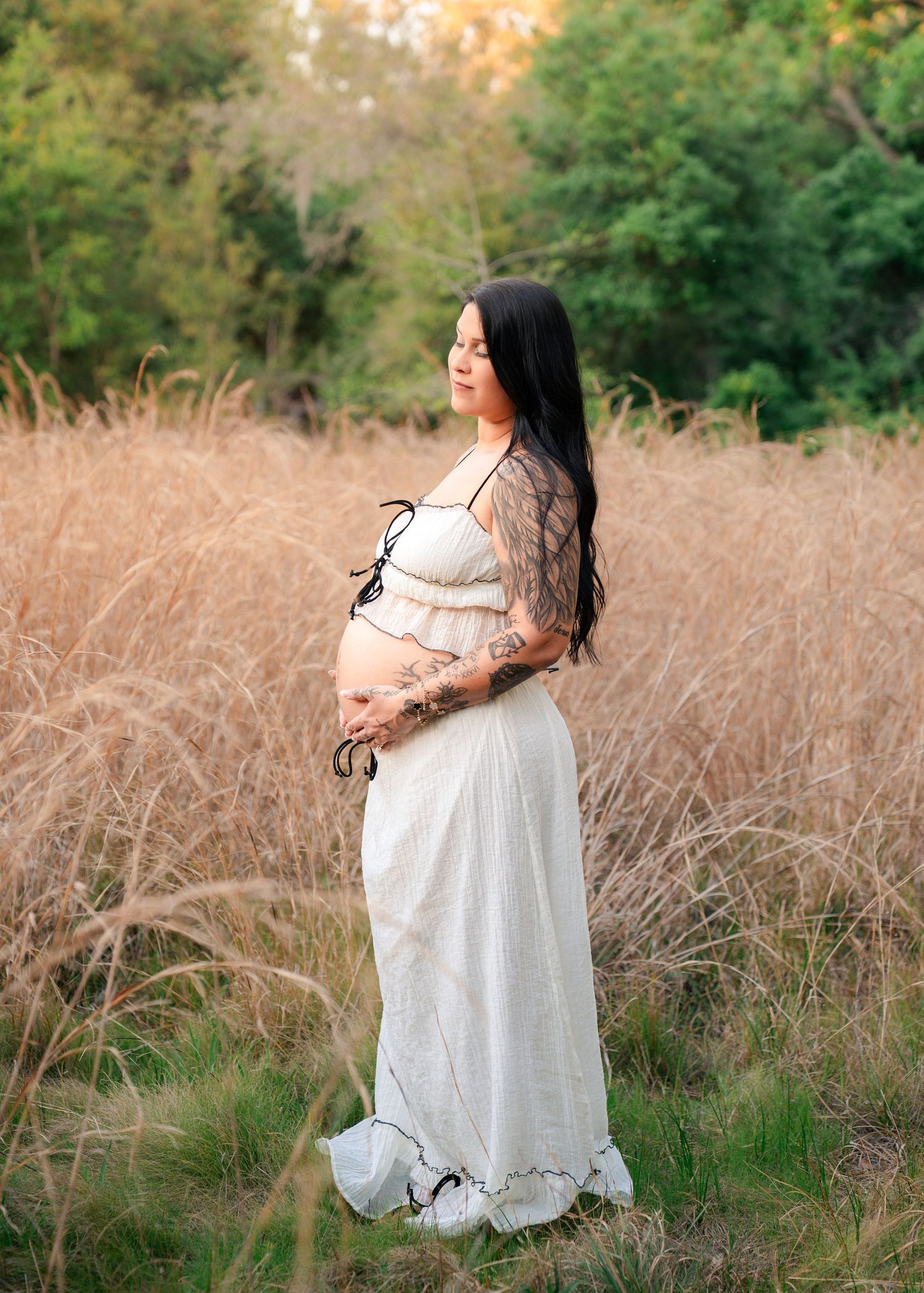 Beautiful maternity portrait of an expecting mother surrounded by tall grass at Lake Runnymede Conservation Area in St Cloud Florida