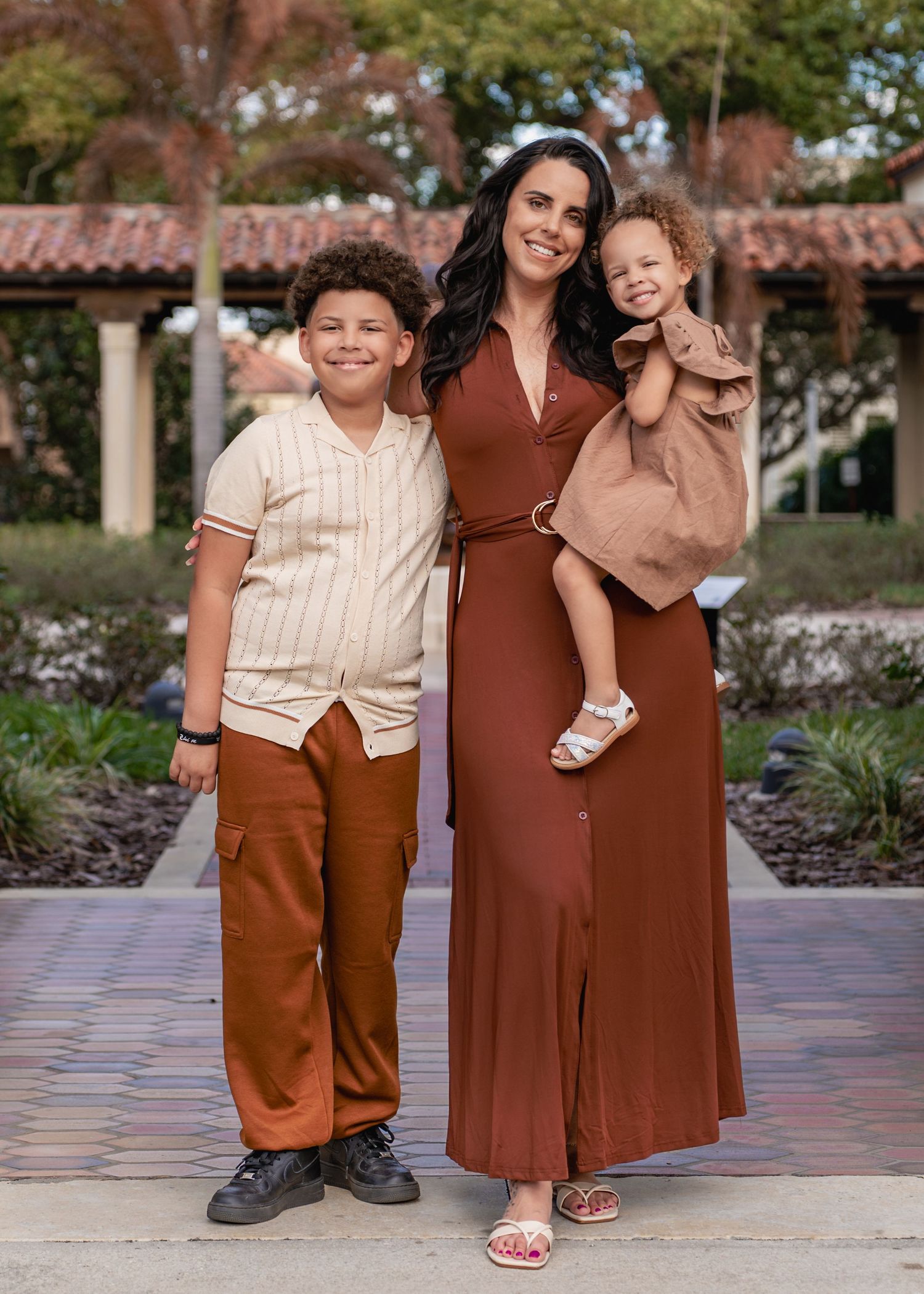 Genuine moments between a mother and her children during a family photography session at Rollins College in Winter Park Florida