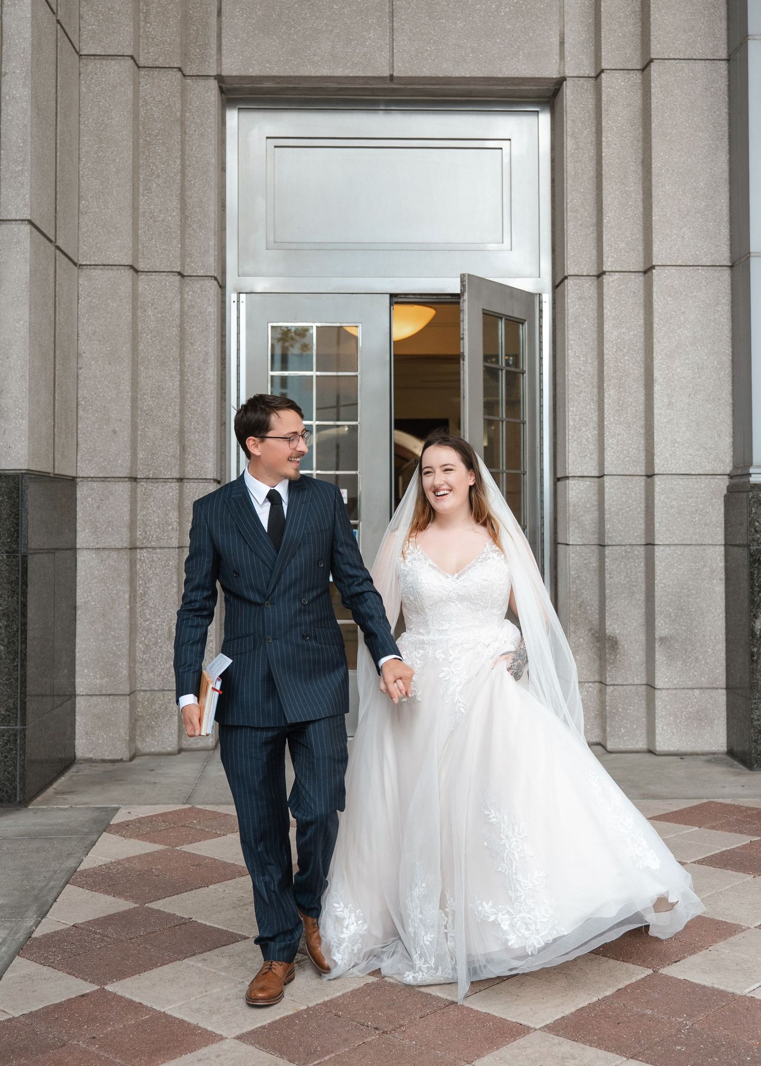 UK newlyweds walking together after their Orlando courthouse wedding