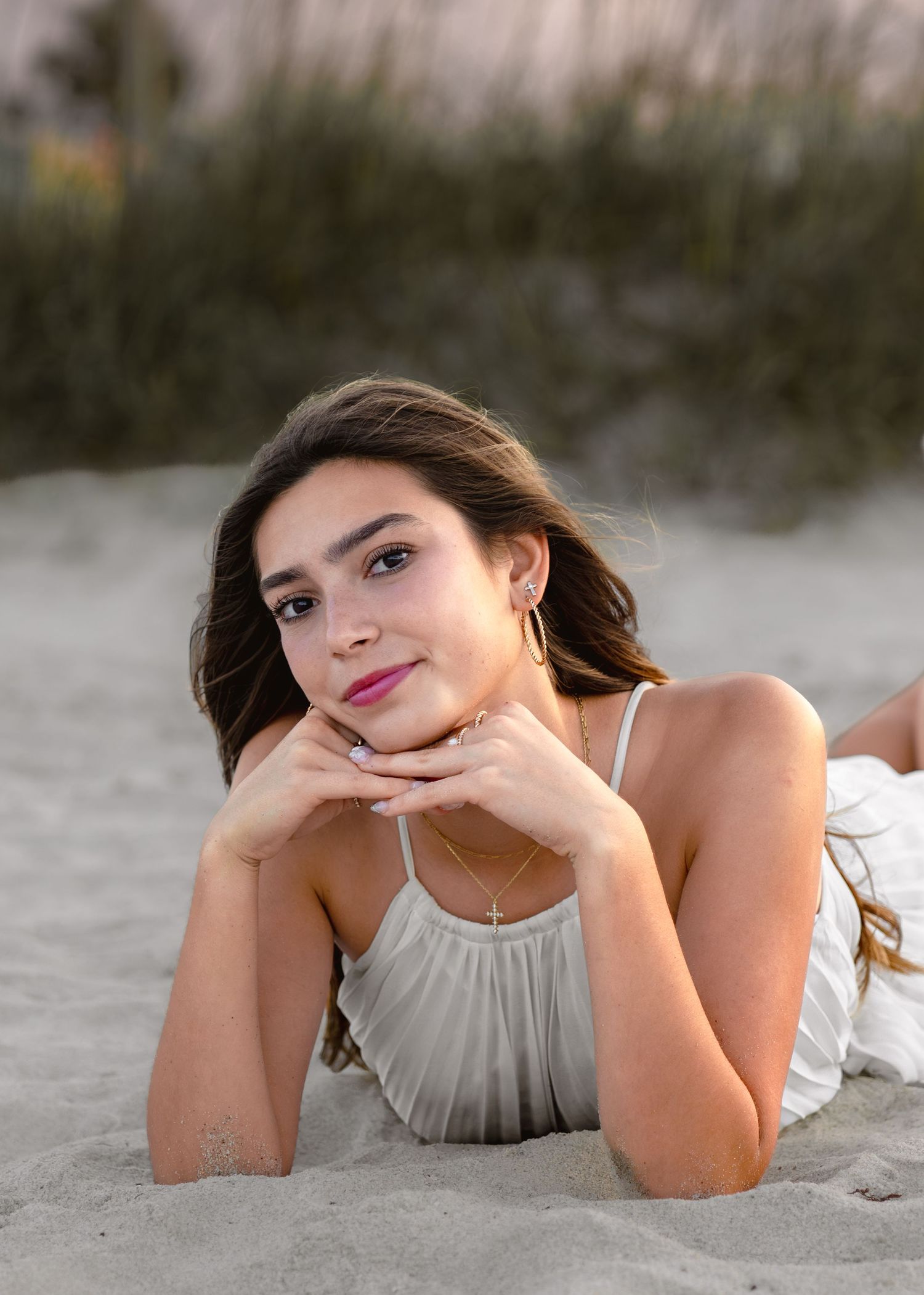 Stunning graduation portrait photography featuring the sandy shoreline and golden sunset at Melbourne Beach