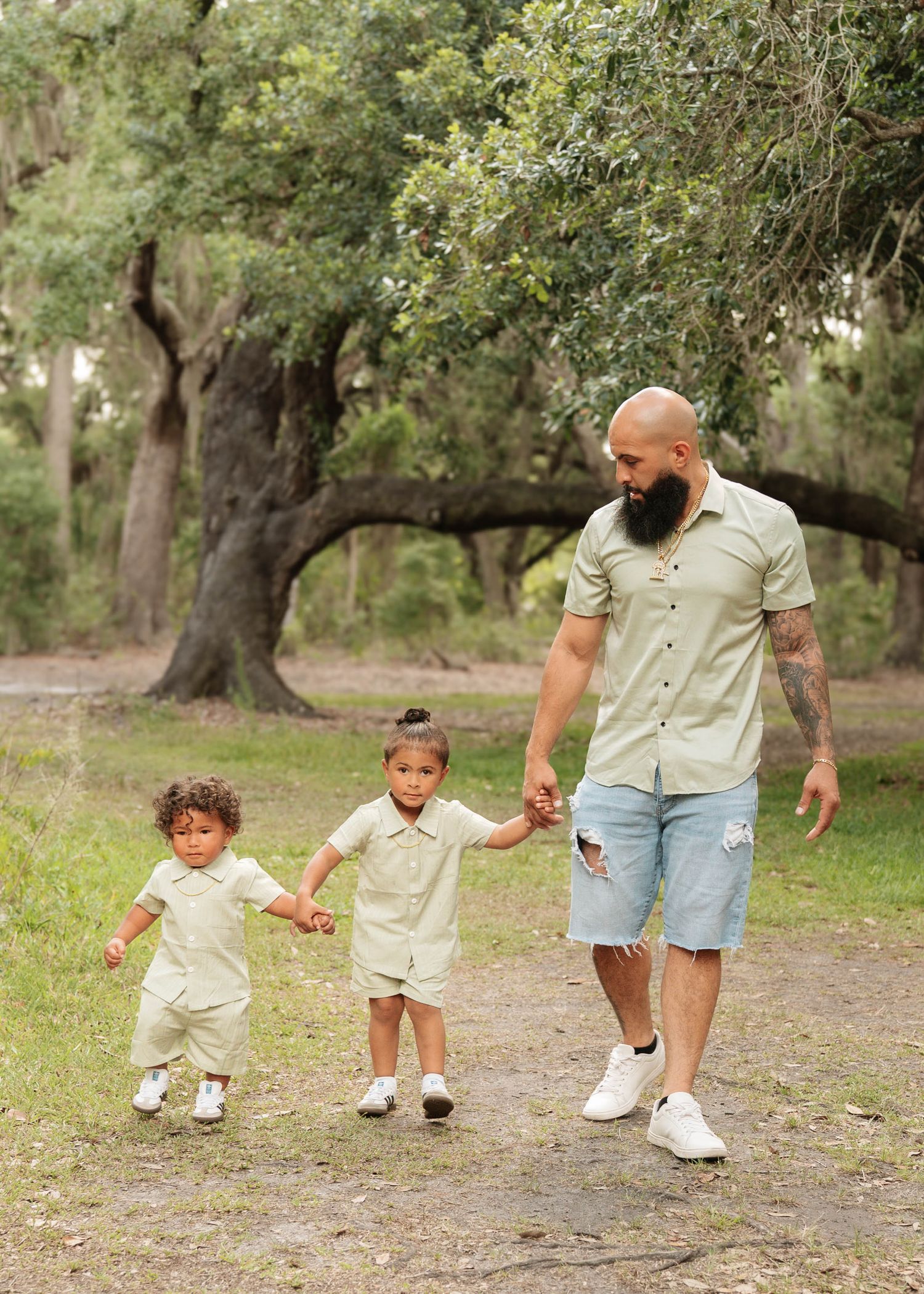 Father and sons enjoying an outdoor Dad and Me photography session at Lake Runnymede Conservation Area in St. Cloud, Florida.