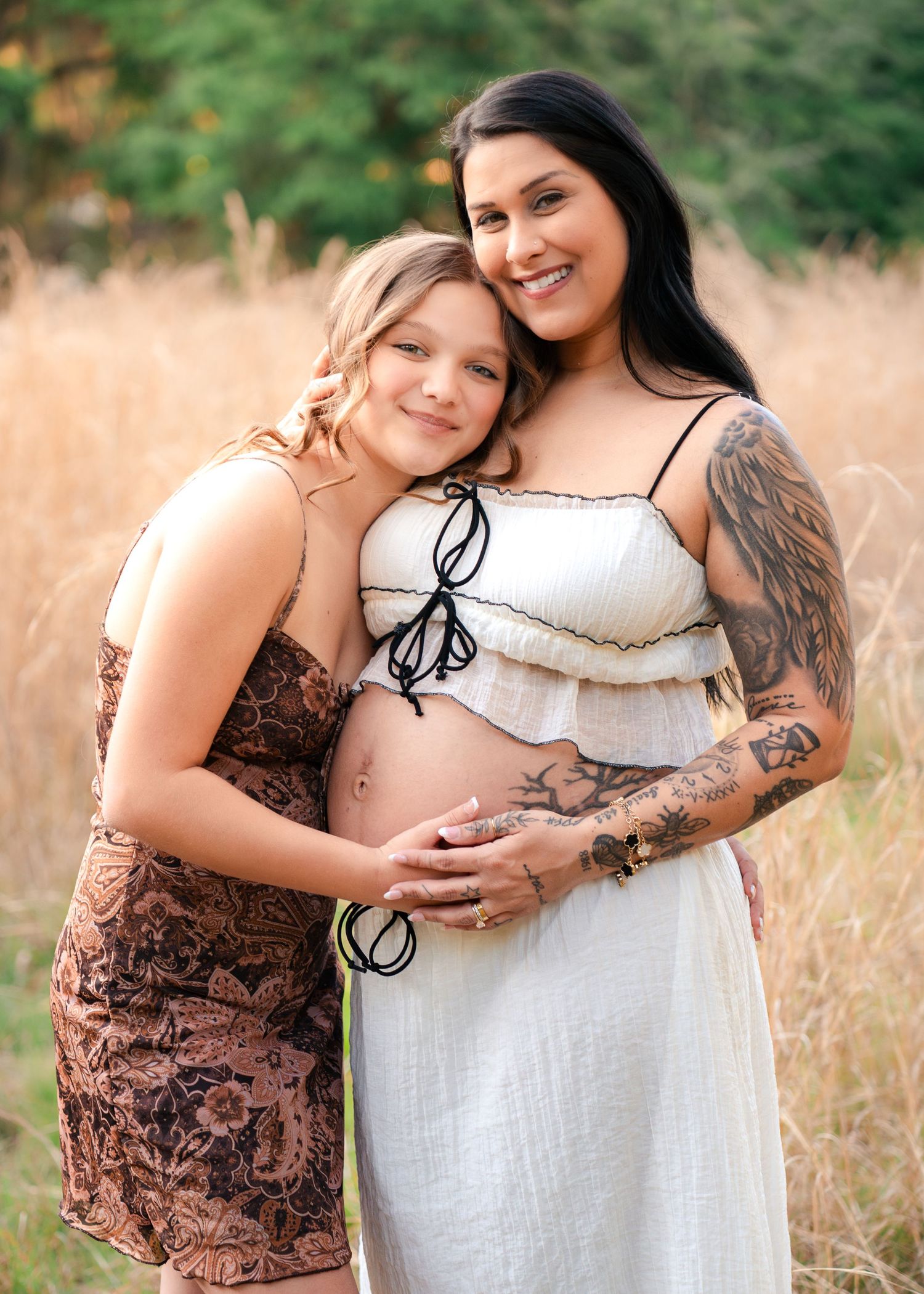 Mother smiling with her daughter during a golden hour maternity session at Lake Runnymede Conservation Area in St Cloud Florida