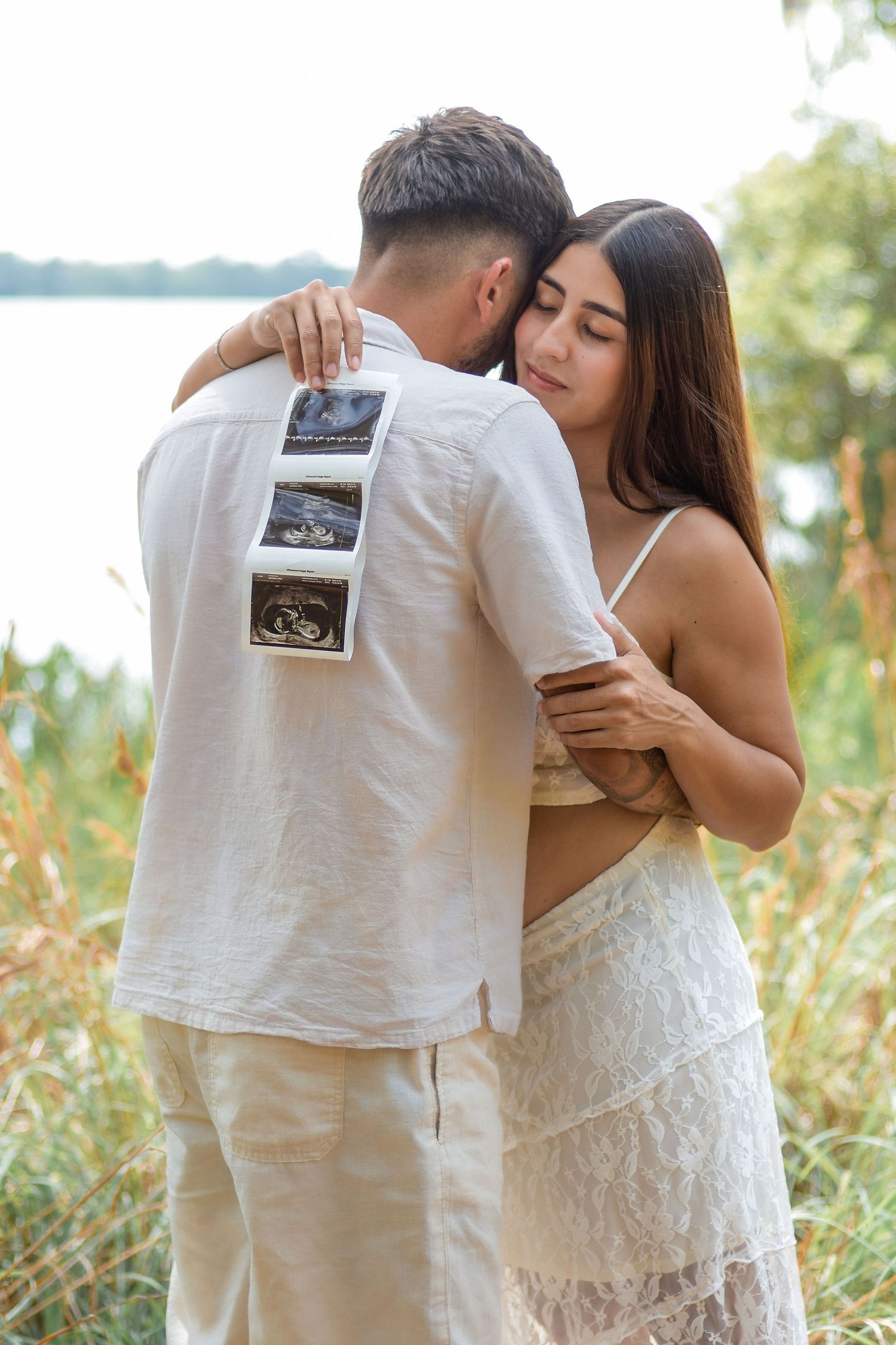 Couple announcing their pregnancy with ultrasound photos in Central Florida by Orlando family photographer Erin Laine Photo