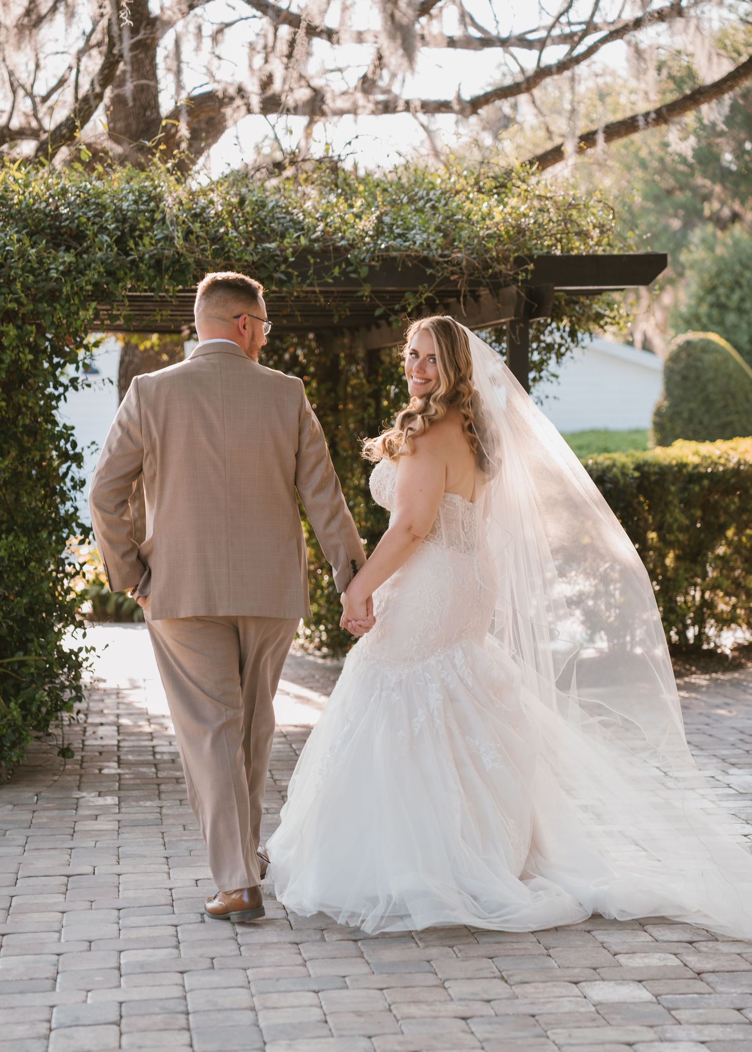 Romantic newlywed portraits capturing the first moments as husband and wife with flowing veil at Moss Estates wedding venue in Eustis