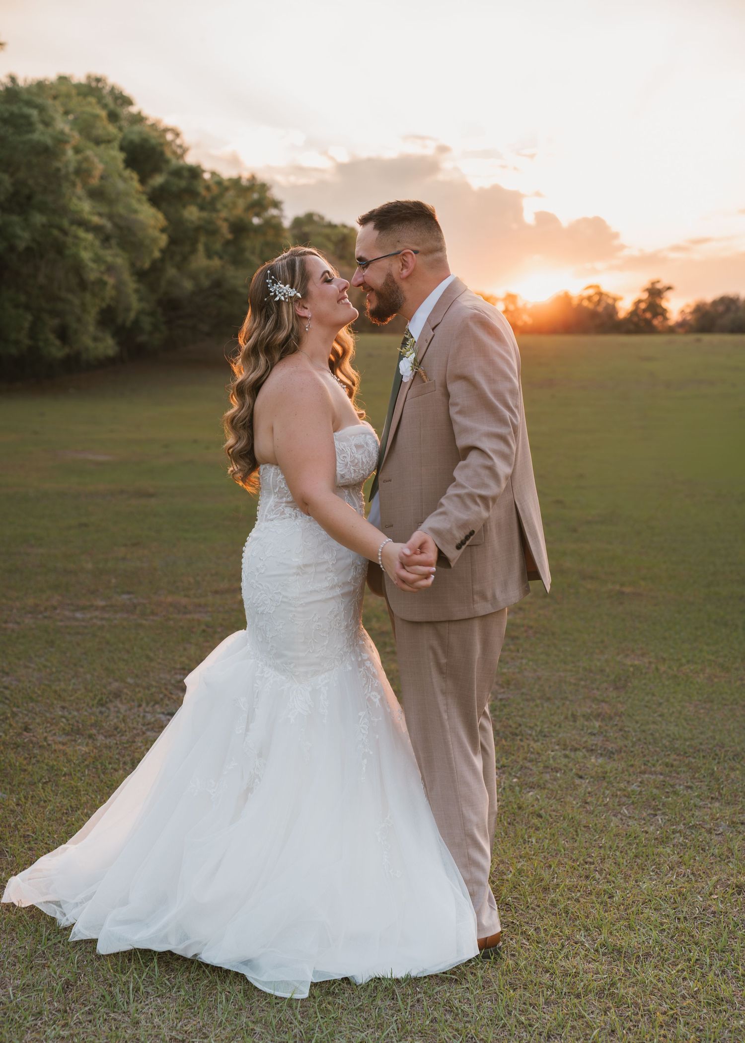 Golden hour portraits highlighting the bride and groom in the scenic fields at Moss Estates wedding venue in Eustis, Florida.