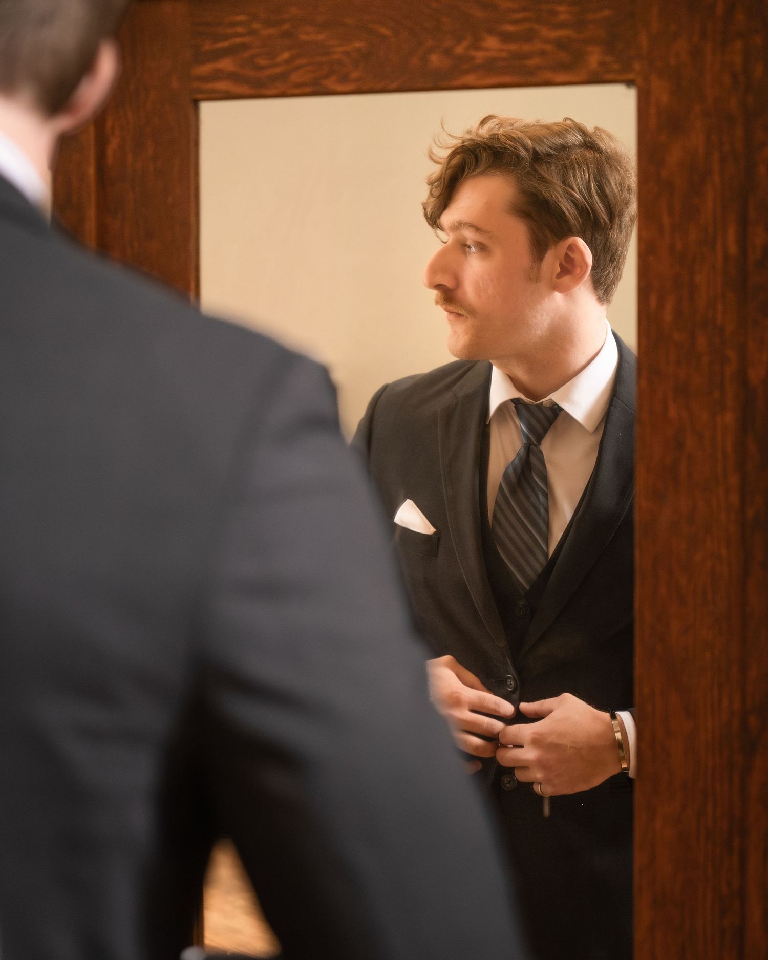Groom portrait captured inside the groom's suite before the ceremony at Historic Venue 1902 wedding venue.