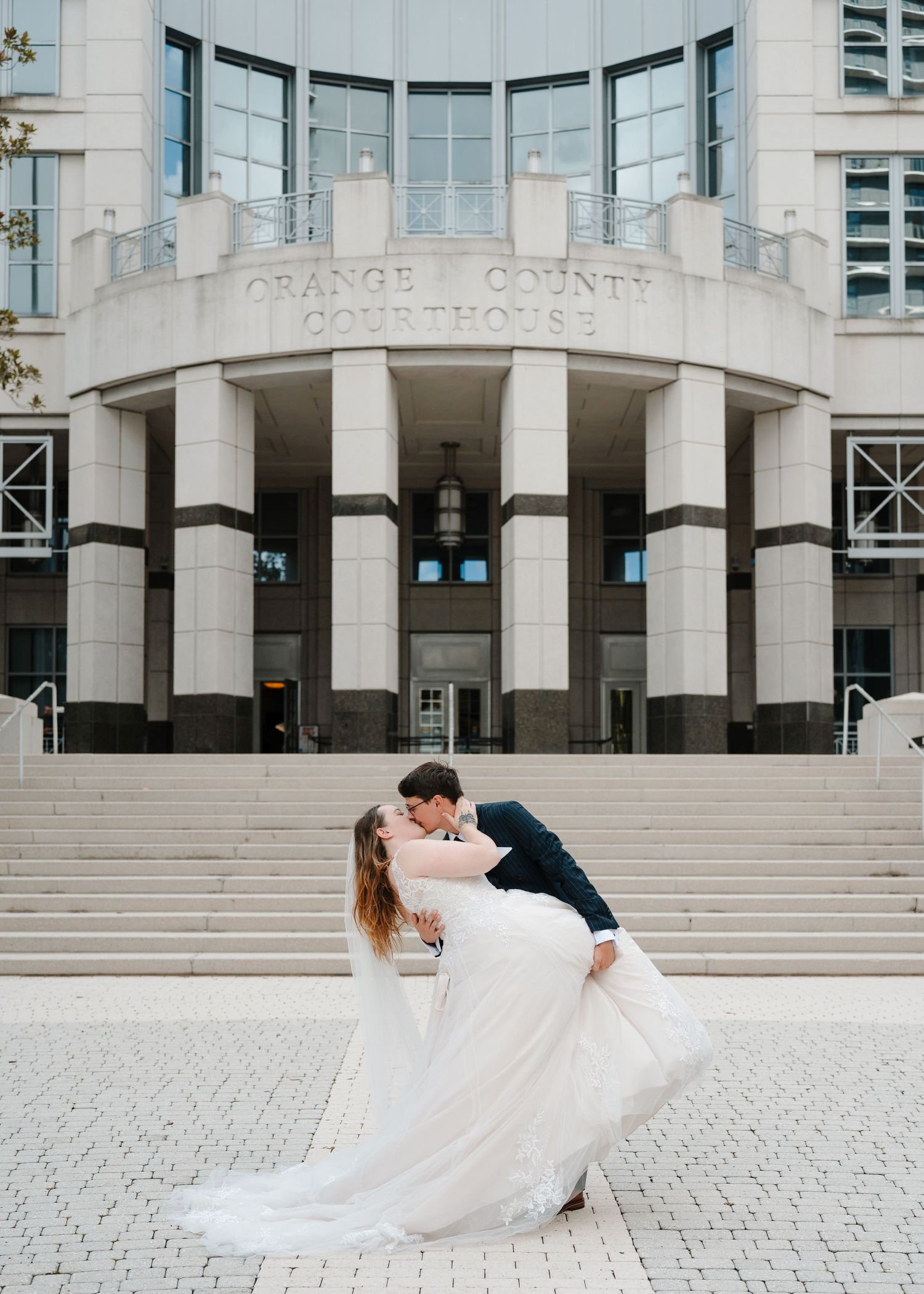 Newlywed couple celebrating outside the Orange County Courthouse after their intimate Florida elopement