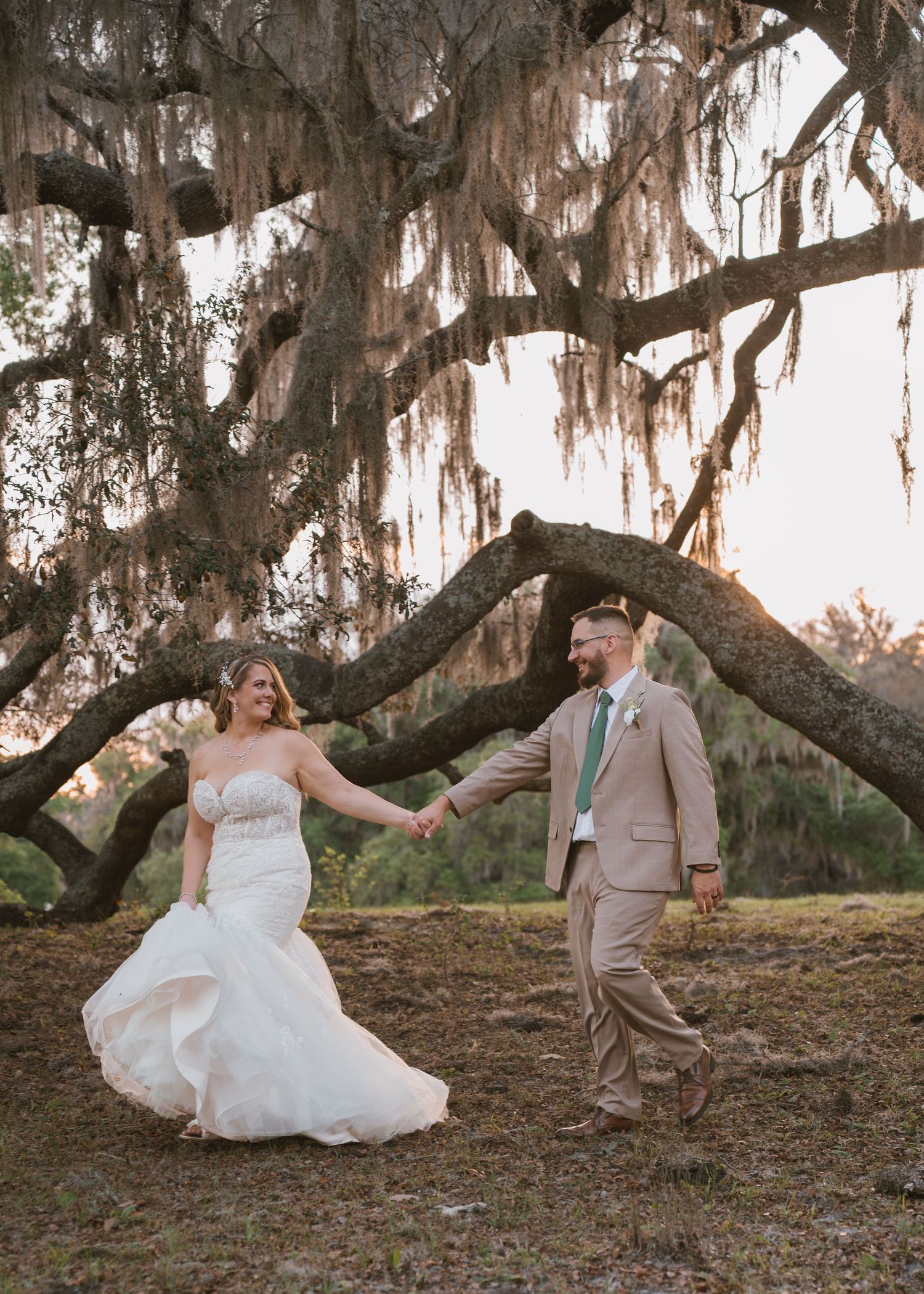 Romantic wedding portraits beneath the beautiful live oak trees at Moss Estates wedding venue in Eustis, Florida, during golden hour.