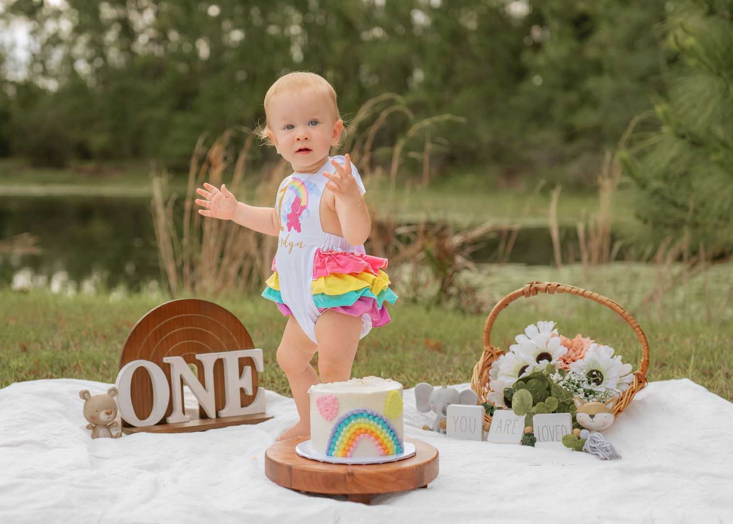 Outdoor cake smash photography documenting the fun and excitement of a first birthday celebration by St Cloud Florida family photographer
