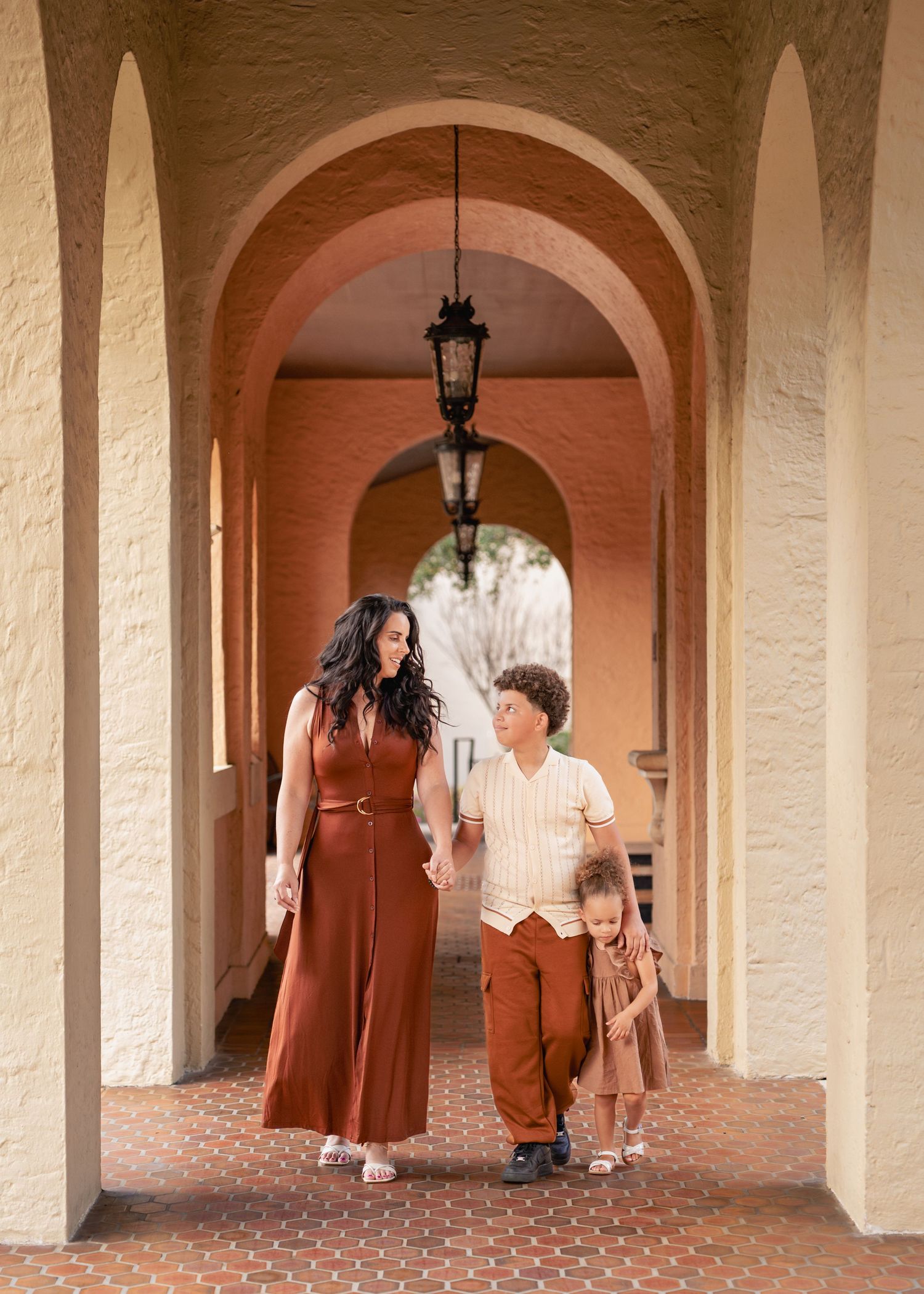 Family portraits framed by the historic Mediterranean architecture of Rollins College in Winter Park.