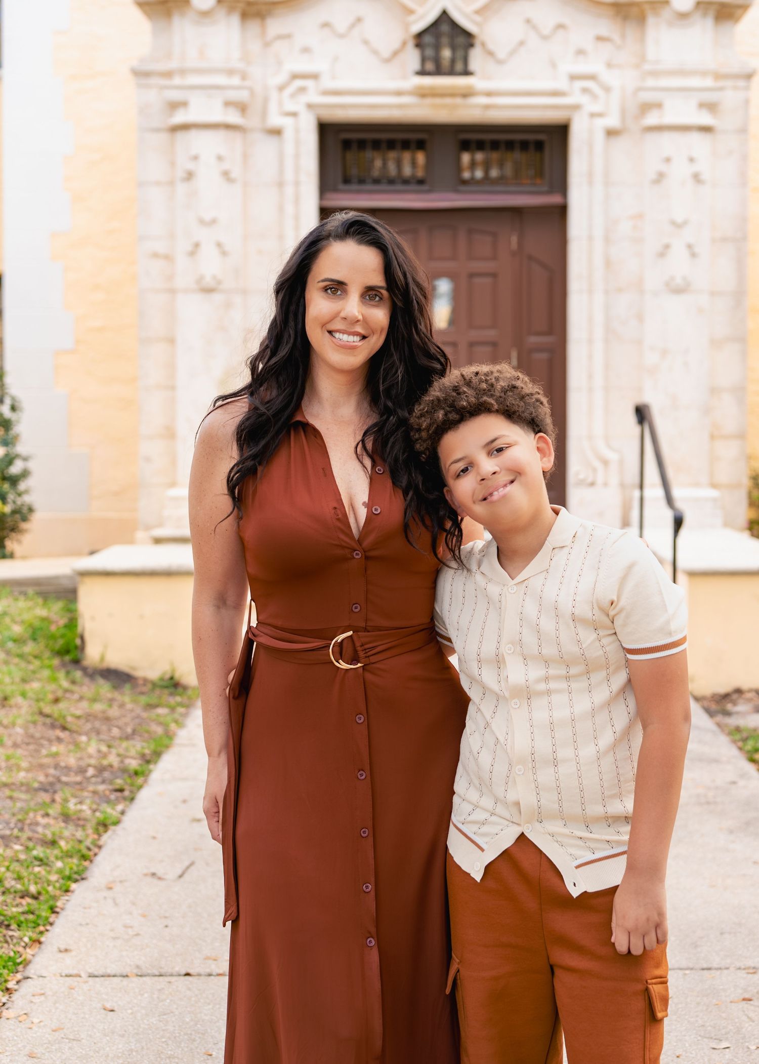 Mother embracing her children during an outdoor family session at Rollins College in Winter Park.