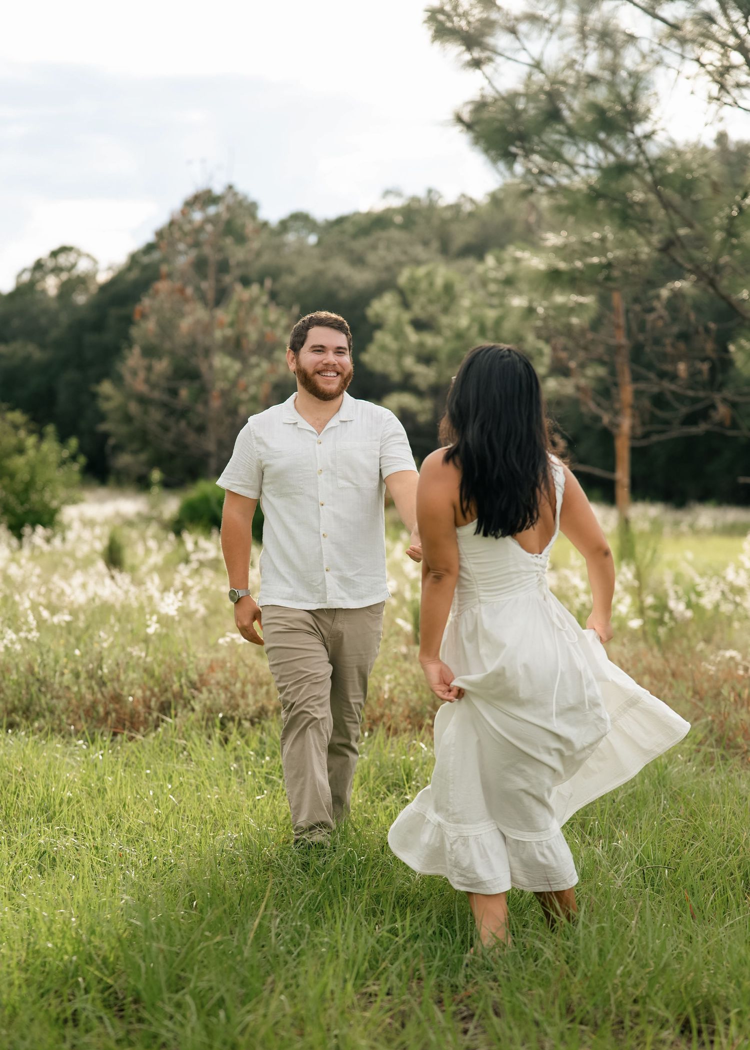 engaged couple frolicking during photoshoot at lake louisa state park
