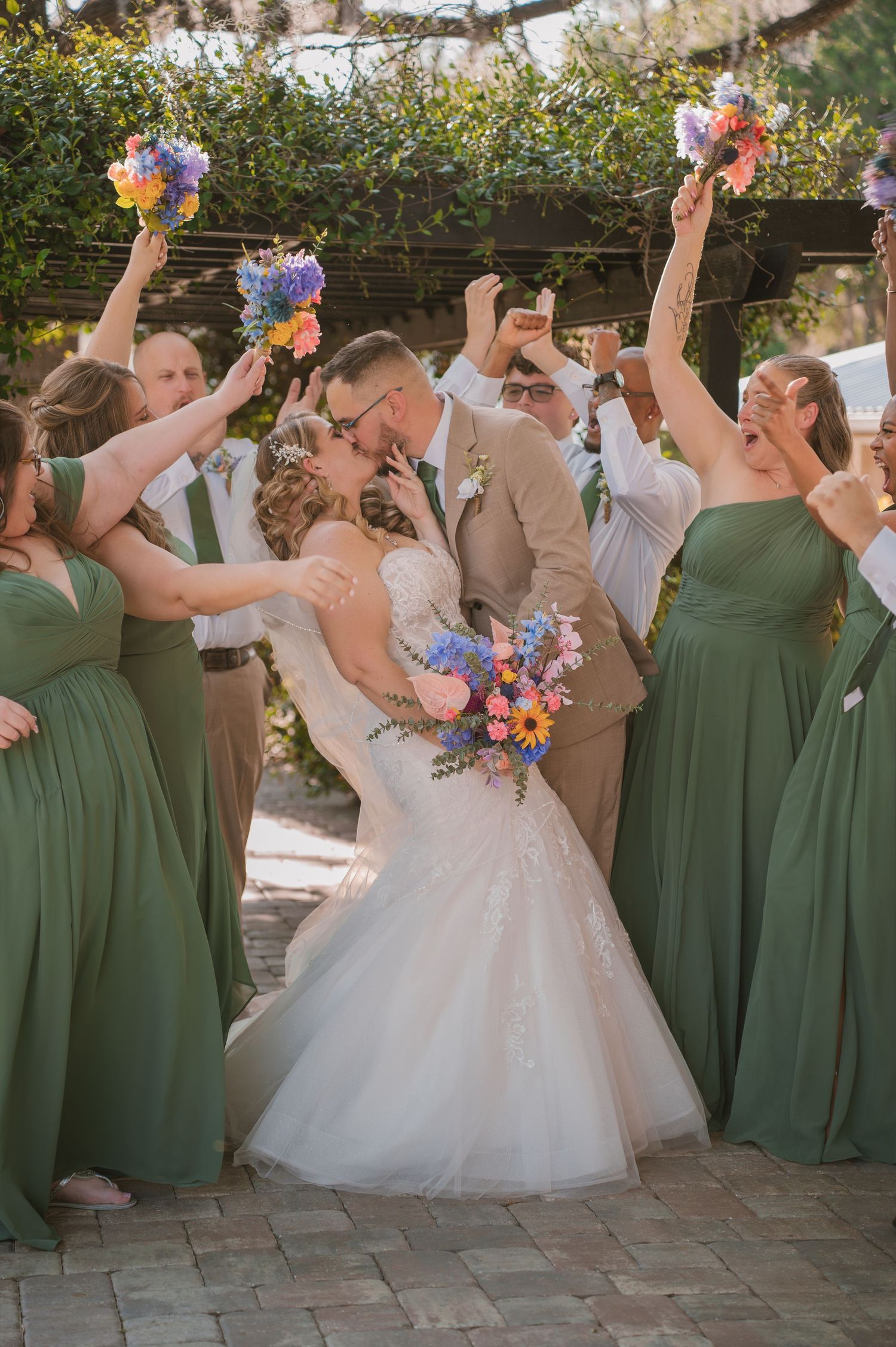 Bride and groom celebrating with their bridal party following the wedding ceremony at Moss Estates wedding venue in Eustis, Florida, surroun