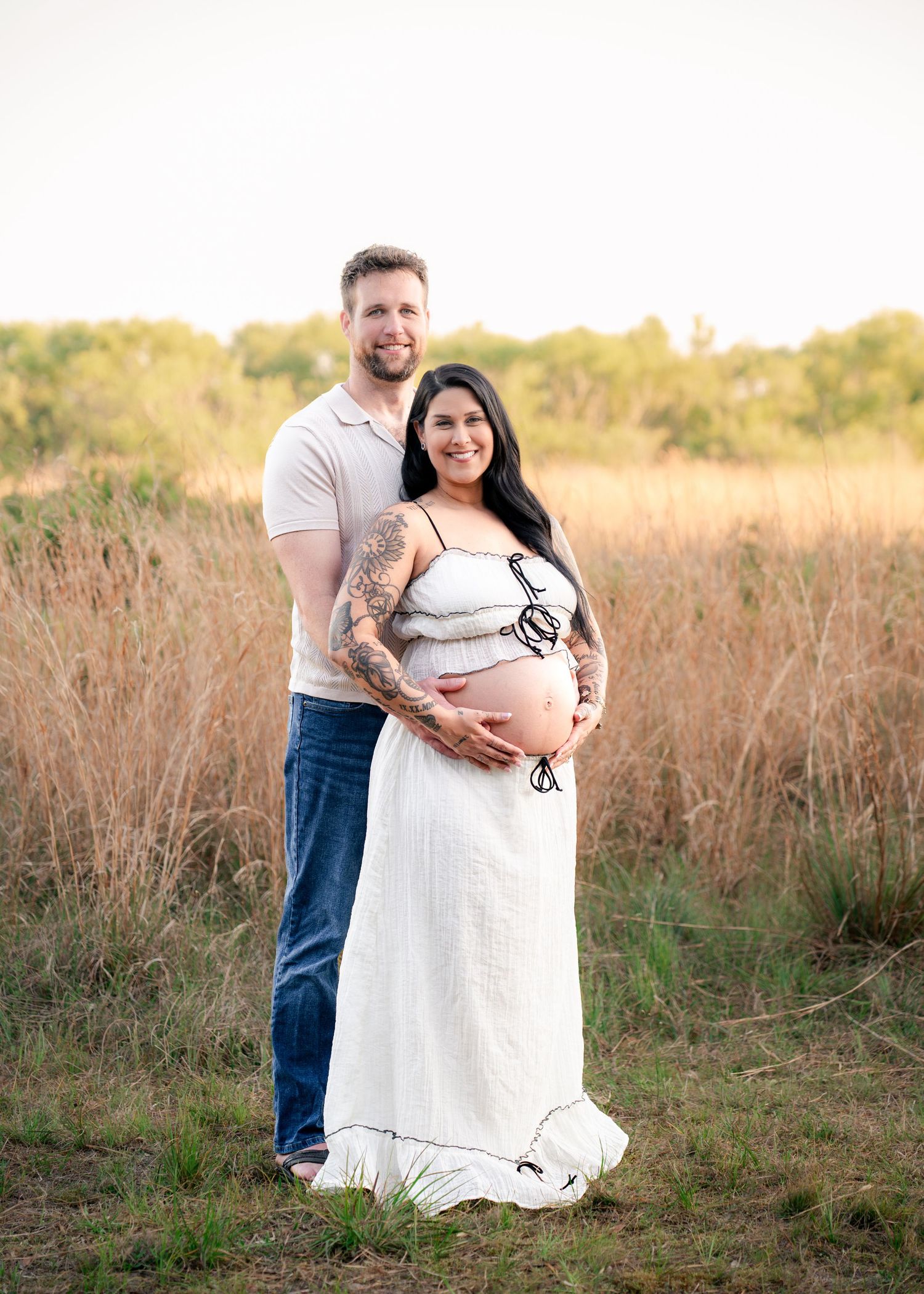 Expecting parents embracing during a golden hour maternity session at Lake Runnymede Conservation Area in St. Cloud, Florida.
