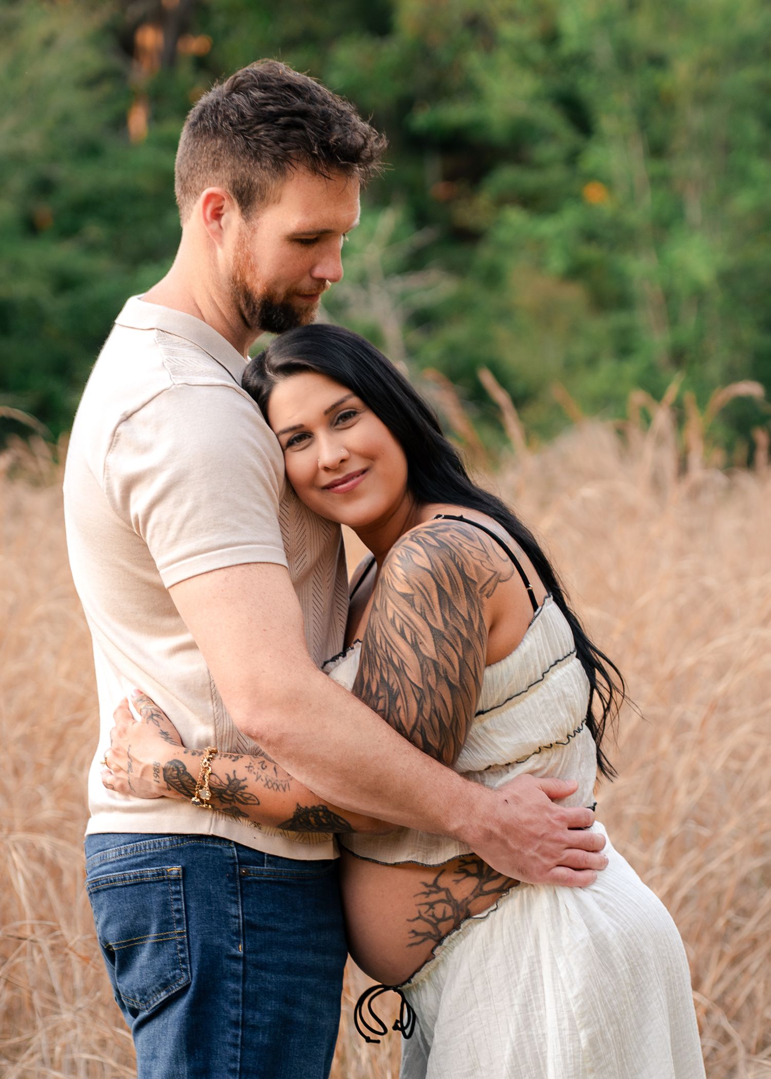 Expecting parents embracing during a golden hour maternity session at Lake Runnymede Conservation Area in St. Cloud, Florida.