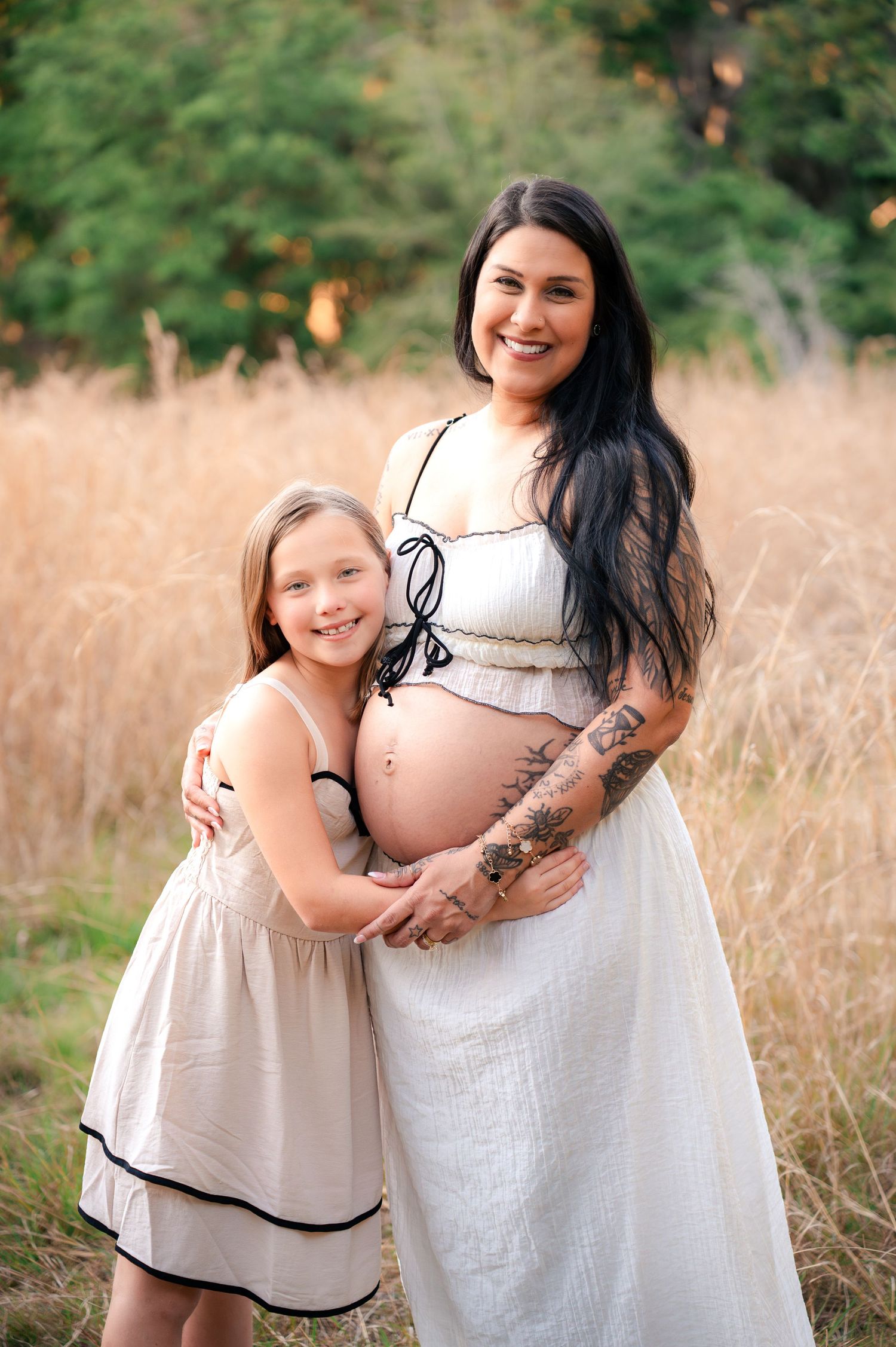 Mother smiling with her daughter during a golden hour maternity session at Lake Runnymede Conservation Area in St Cloud Florida