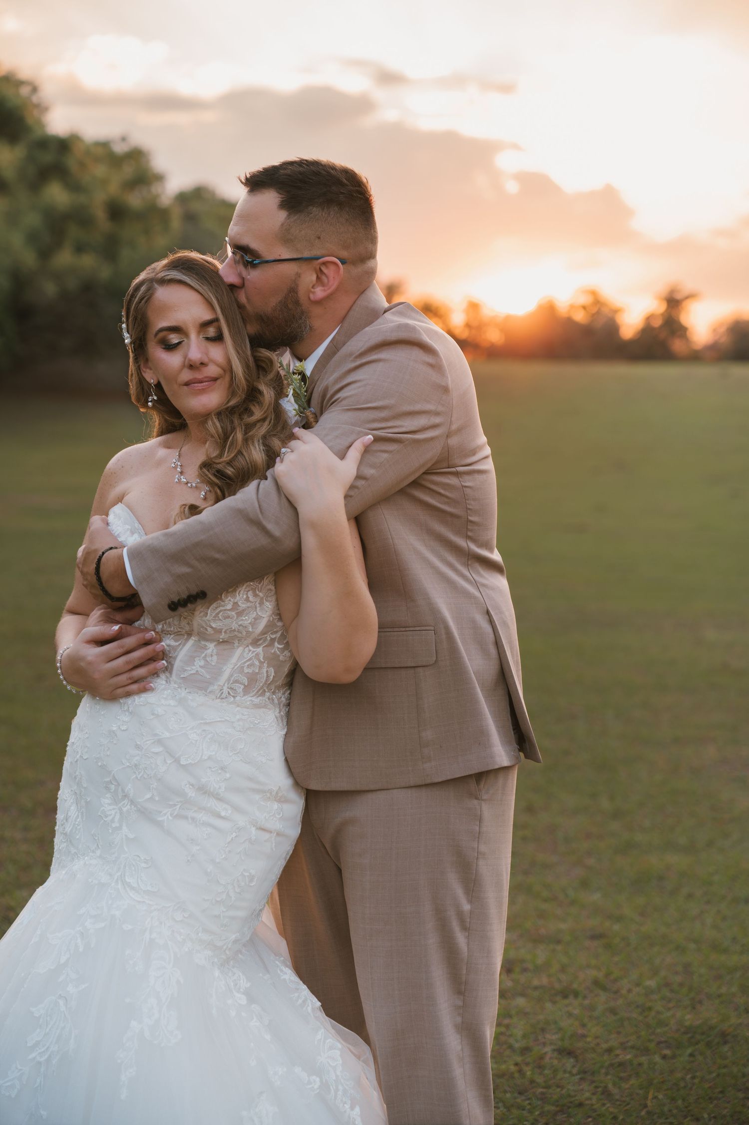 Golden hour portraits highlighting the bride and groom in the scenic fields at Moss Estates wedding venue in Eustis, Florida.