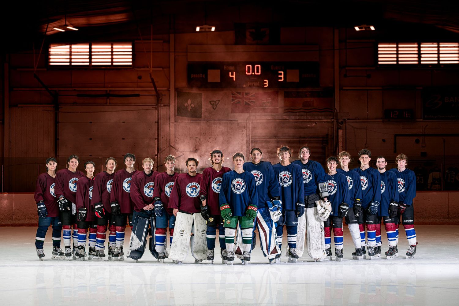 Cinematic on-ice hockey team U18 Grad Game portrait in the Flying V set up with lighting and atmospheric smoke effects in Russell, Ontario