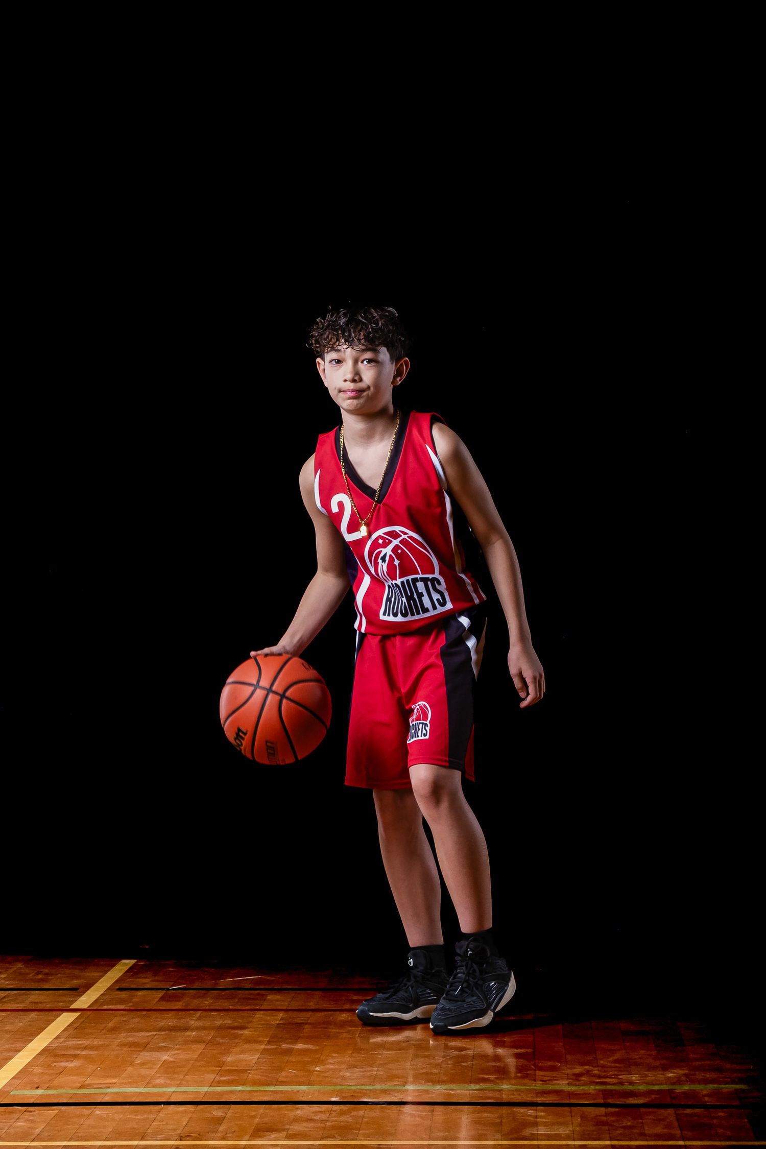 Cinematic basketball action portrait of an athlete using dramatic studio lighting and effects by The Show Sports Media