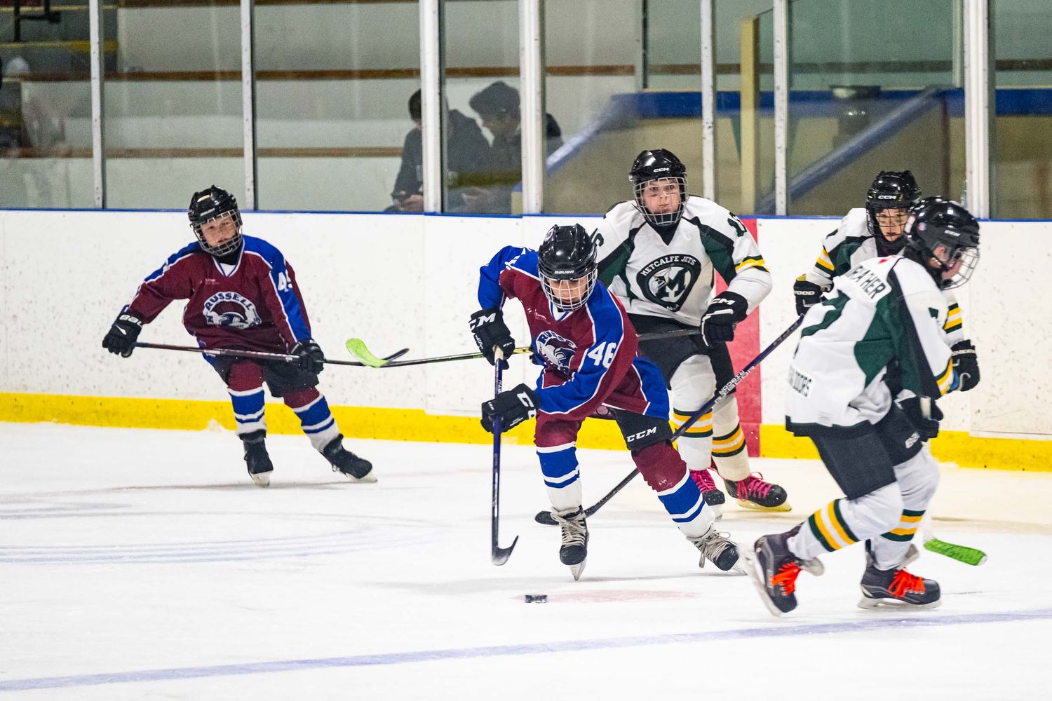 Two teams battle for the puck in a high-intensity hockey action shot during a live game in The GTA